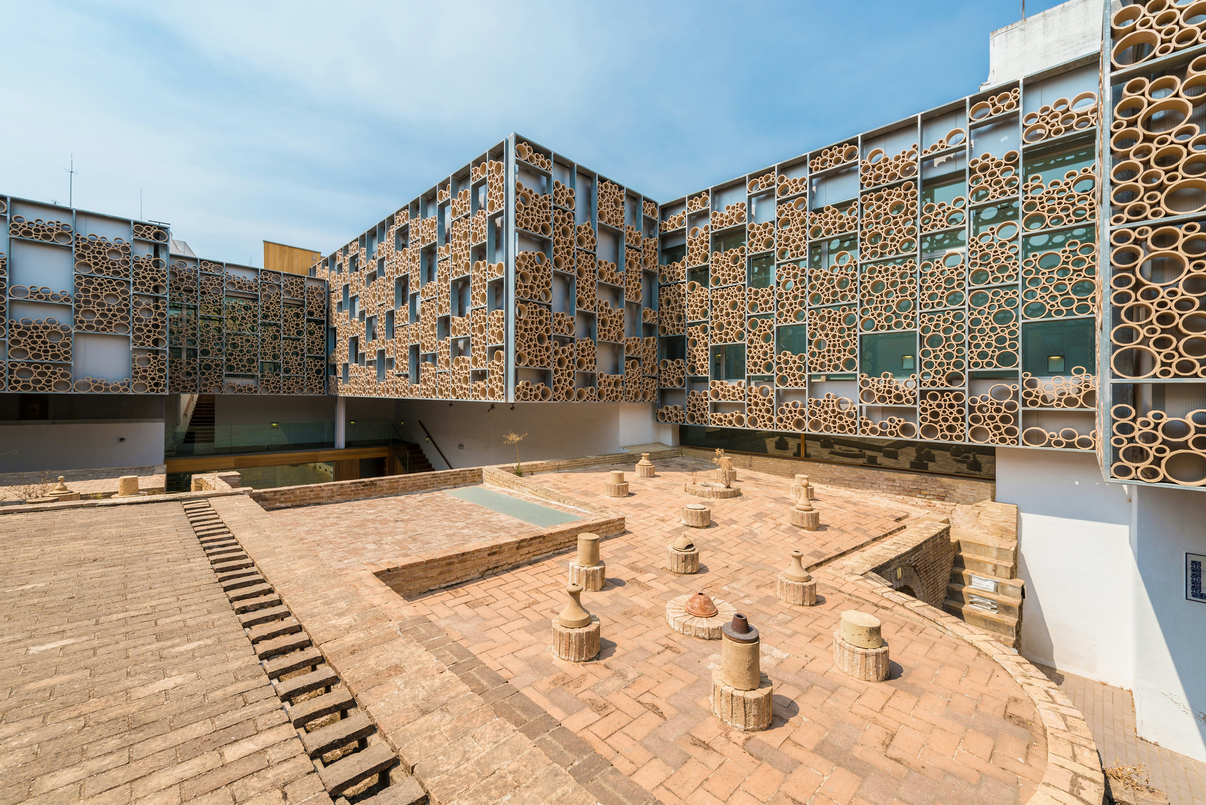 Exterior of a modern building lined with ceramic tubes and tiles