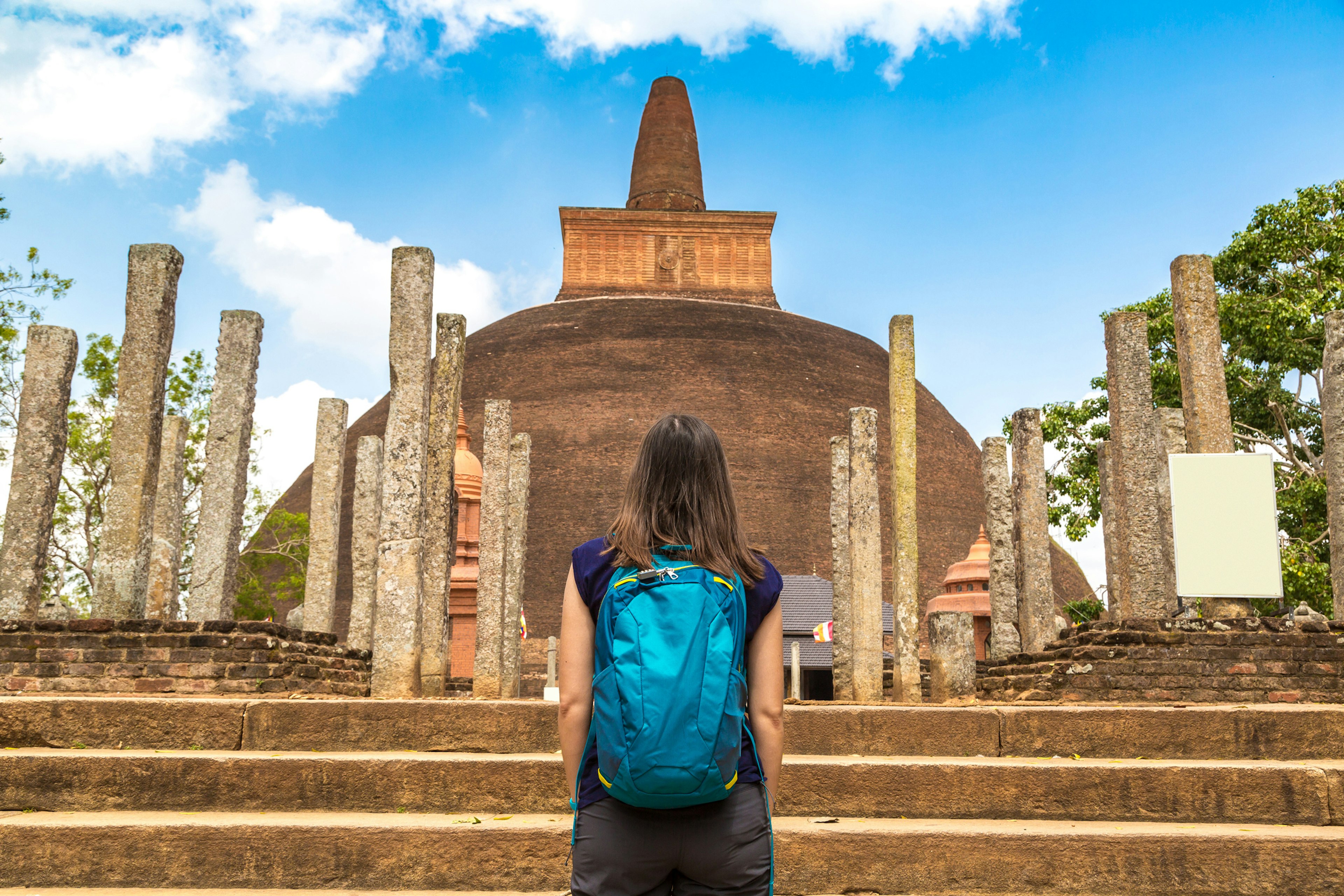 A girl looks at the ruins of the Abhayagiri stupa at Anuradhapura, Sri Lanka.