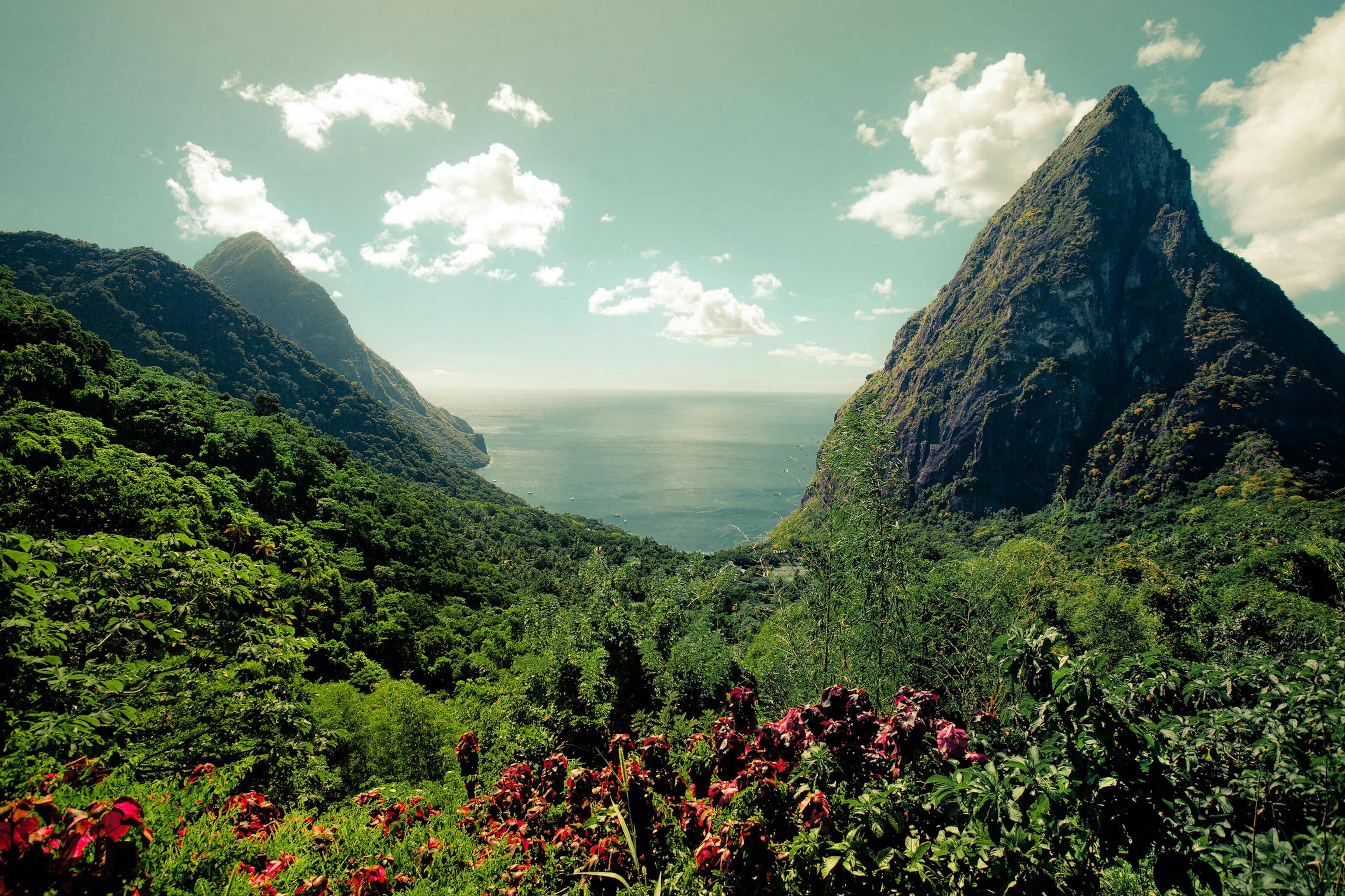 View of the verdant Pitons in St Lucia with the Caribbean Sea beyond