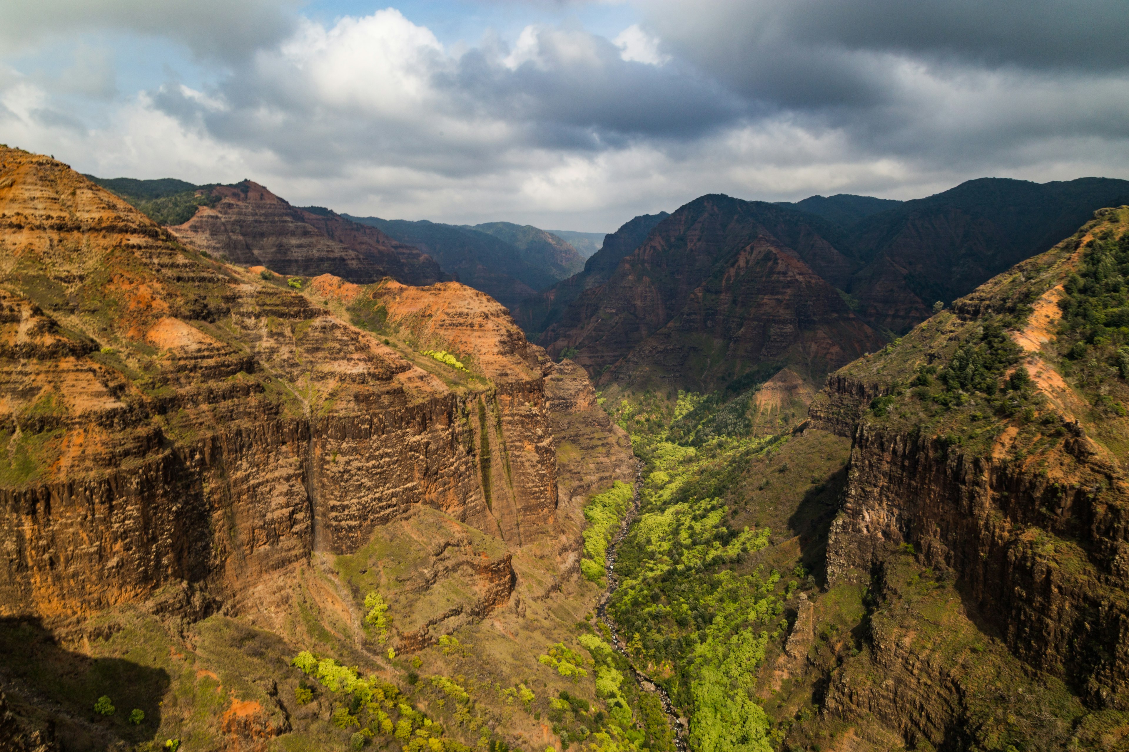 A canyon with sheer brown-red rock walls