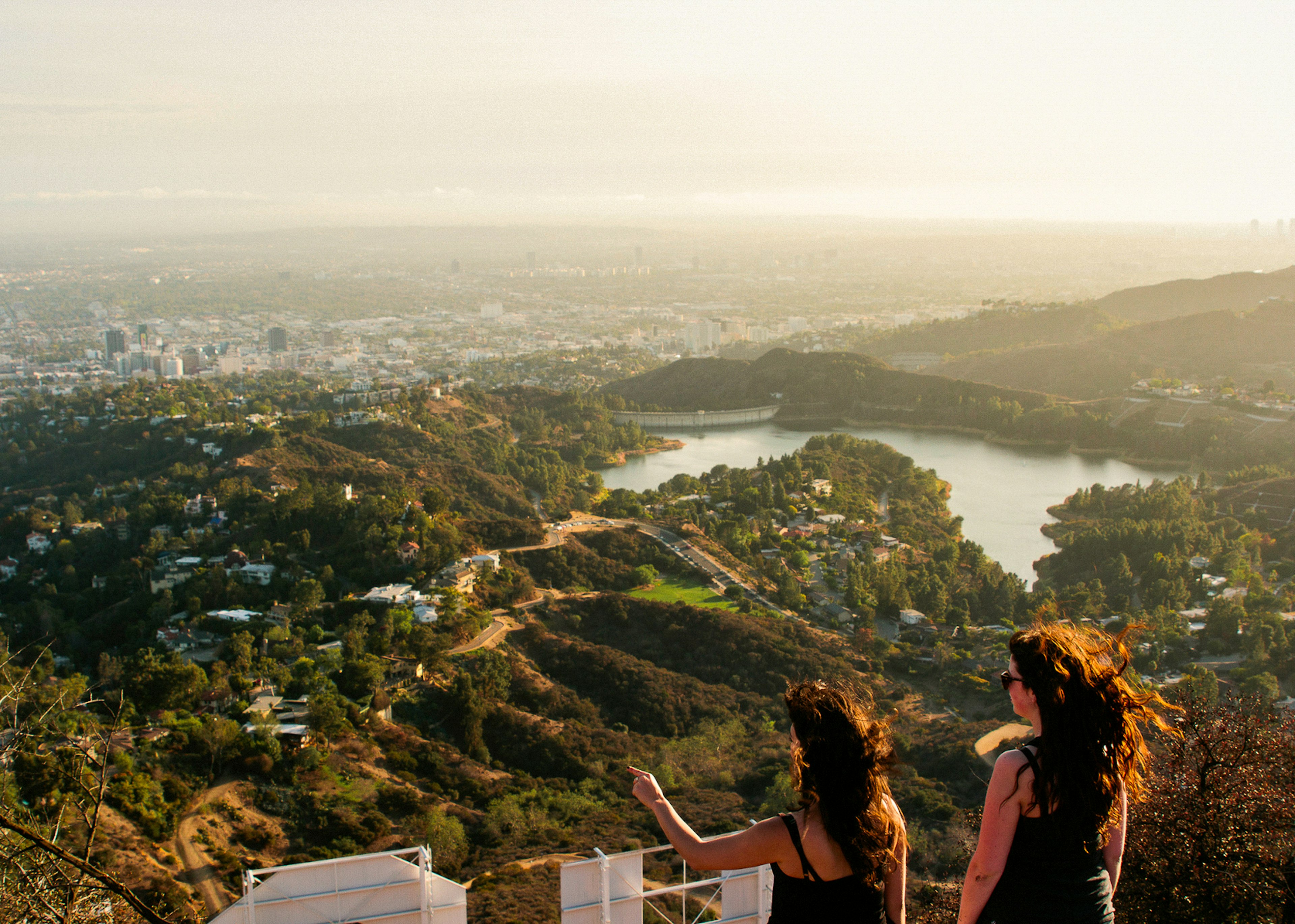 Two woman looking out over the Los Angeles skyline.