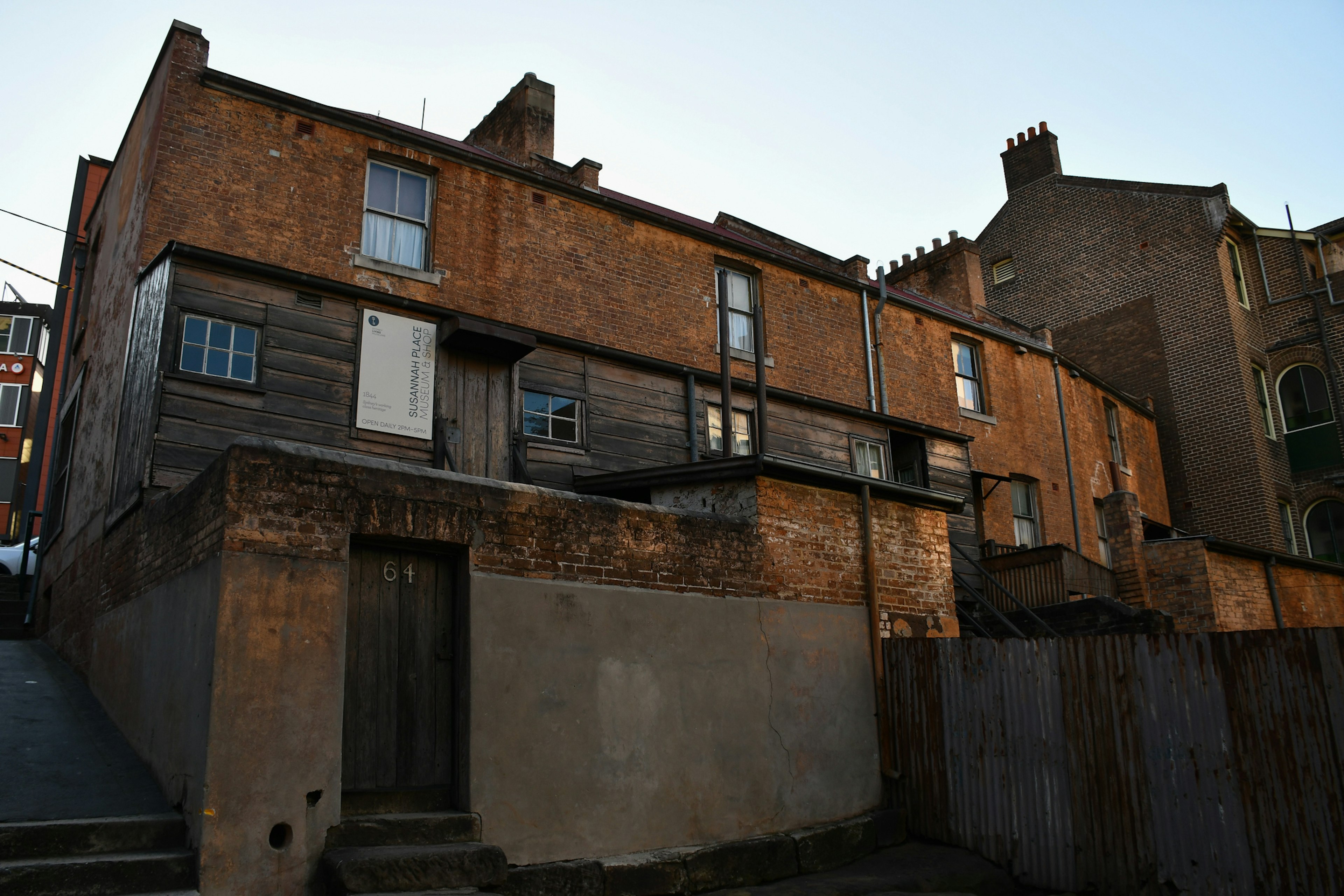 An exterior shot of Susannah Place's main entrance of a small brown building make of wood and brick