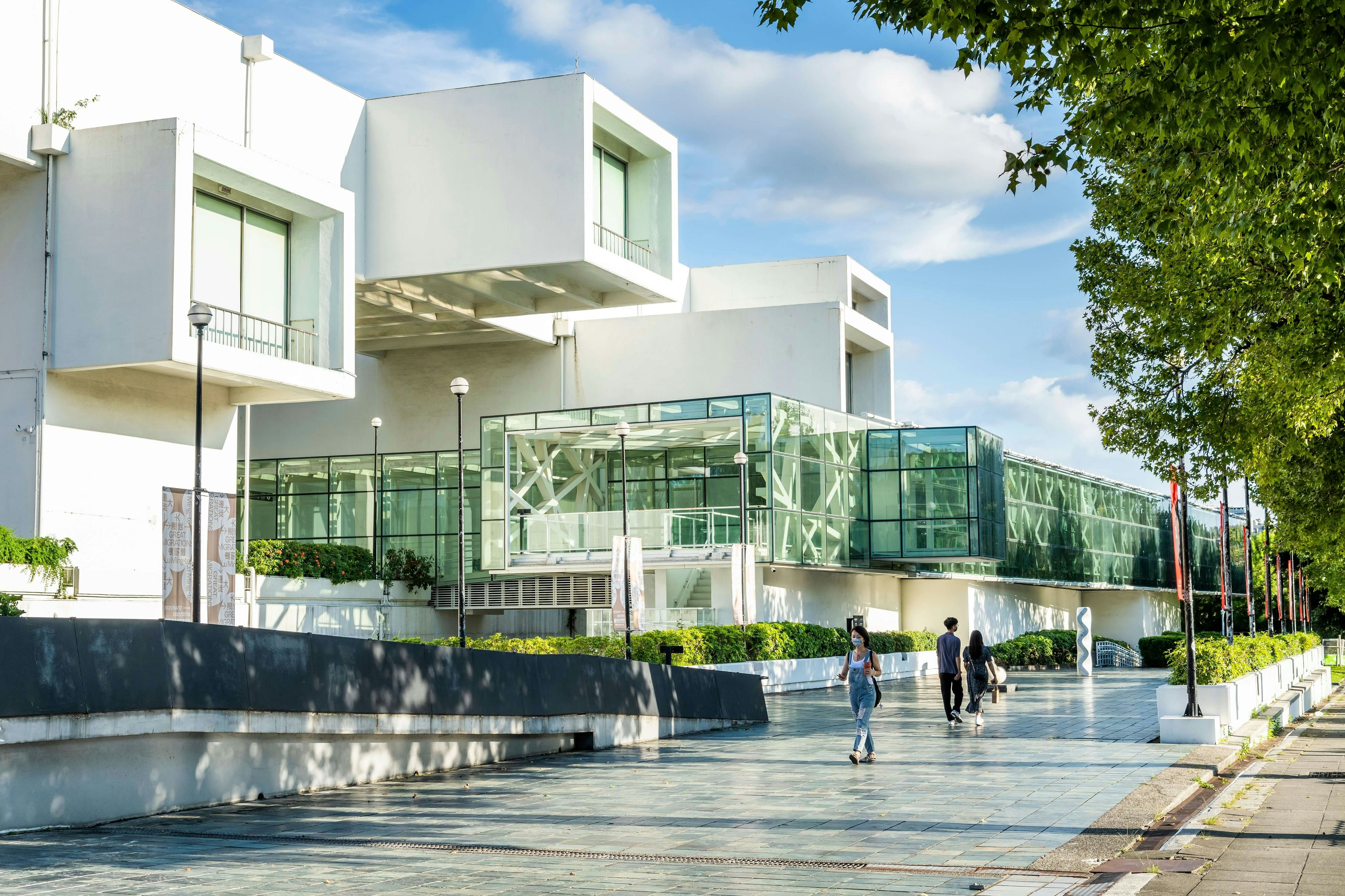 Building view of people walking by the Taipei Fine Arts Museum, the first museum in Taiwan built for contemporary art exhibitions