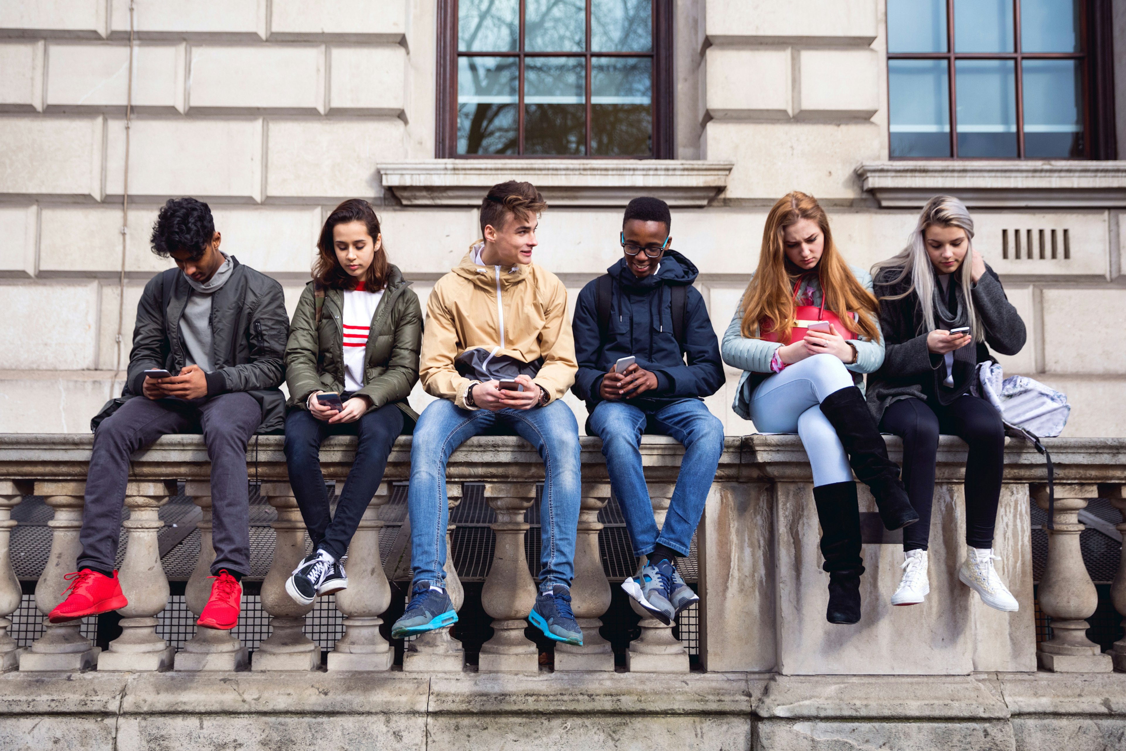 Teenagers students using smartphone on a school break