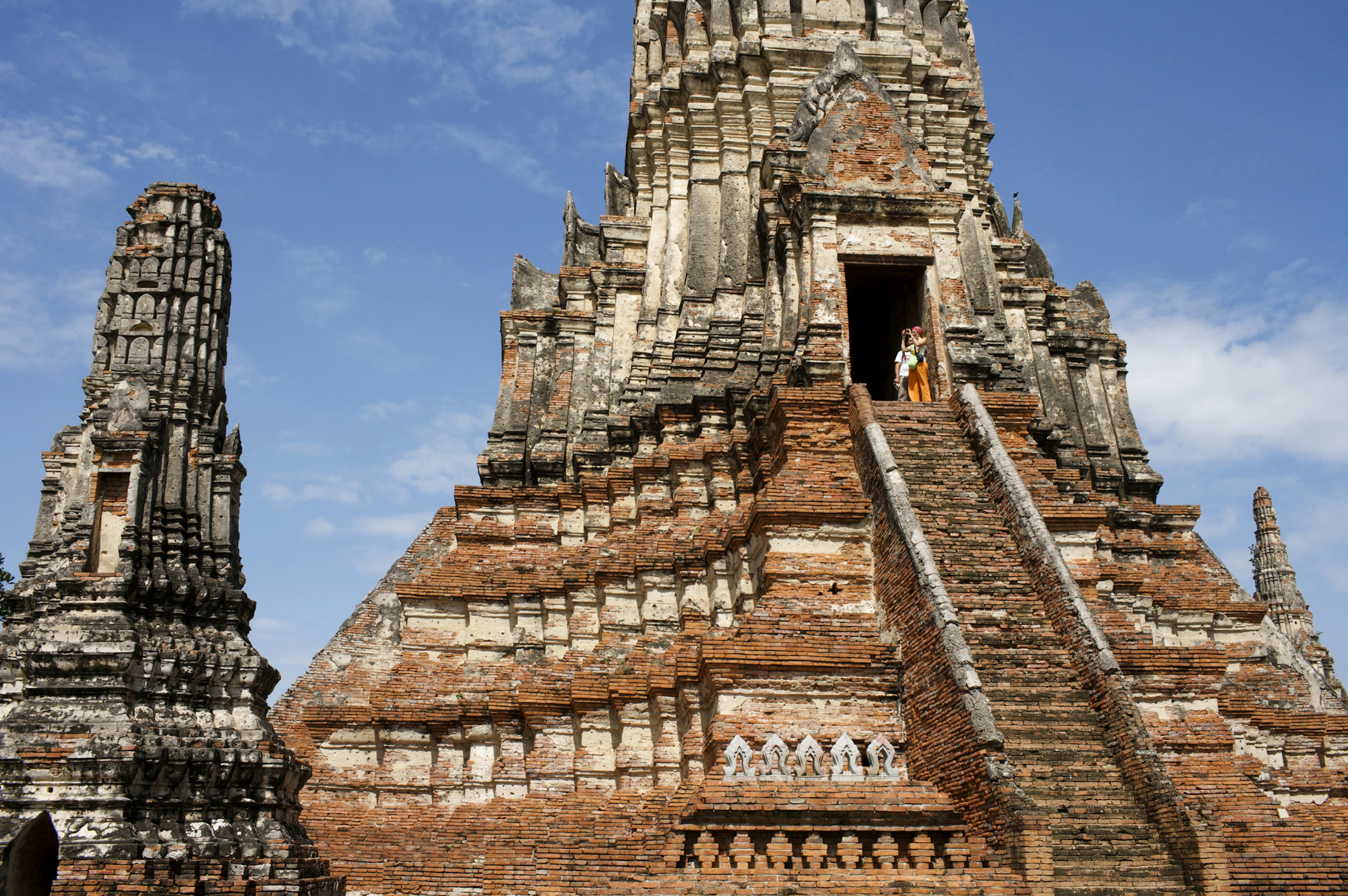 Travelers climb the steps to Wat Chaiwattanaram in Ayutthaya, Thailand.