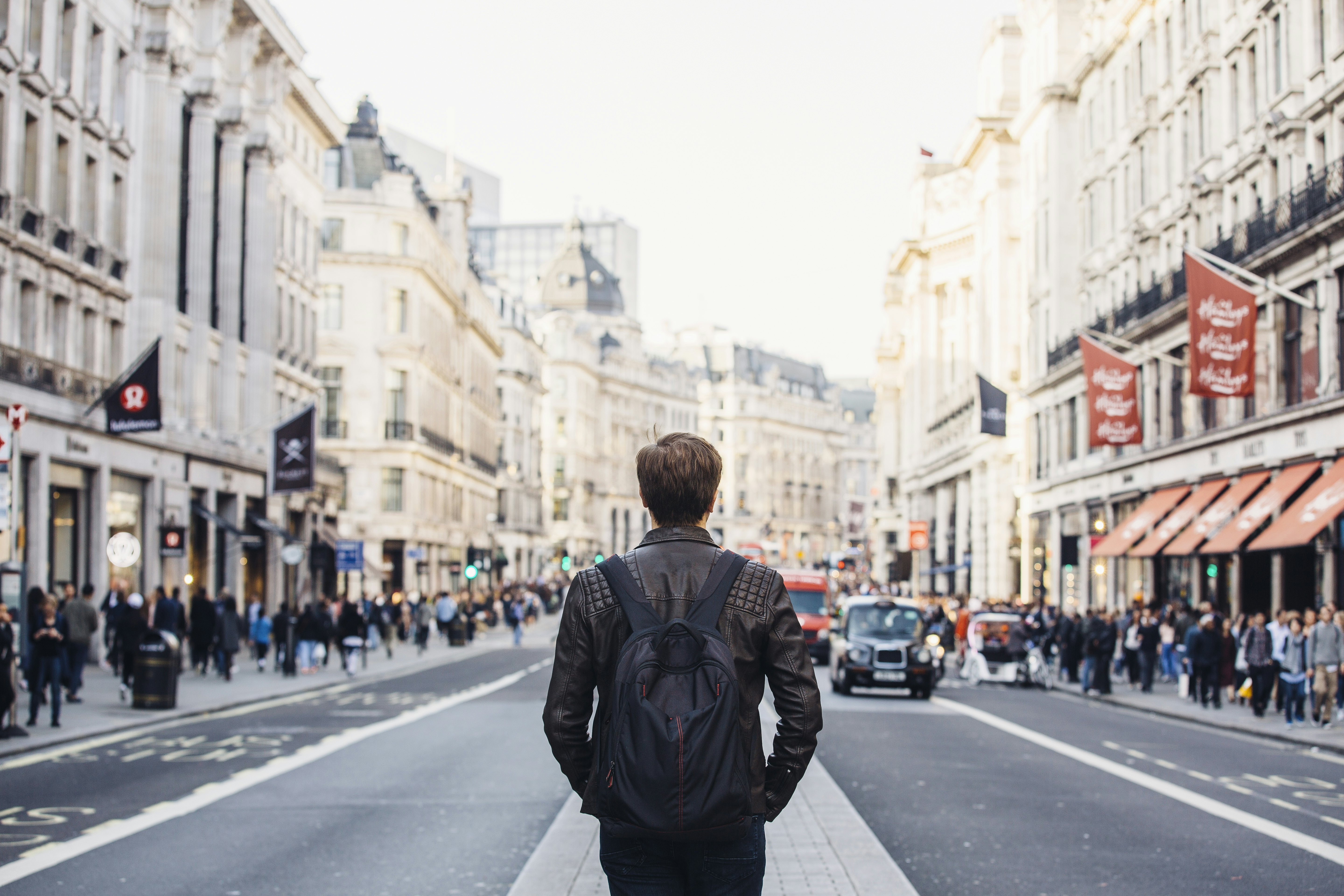 Tourist with backpack walking on Regent Street in London