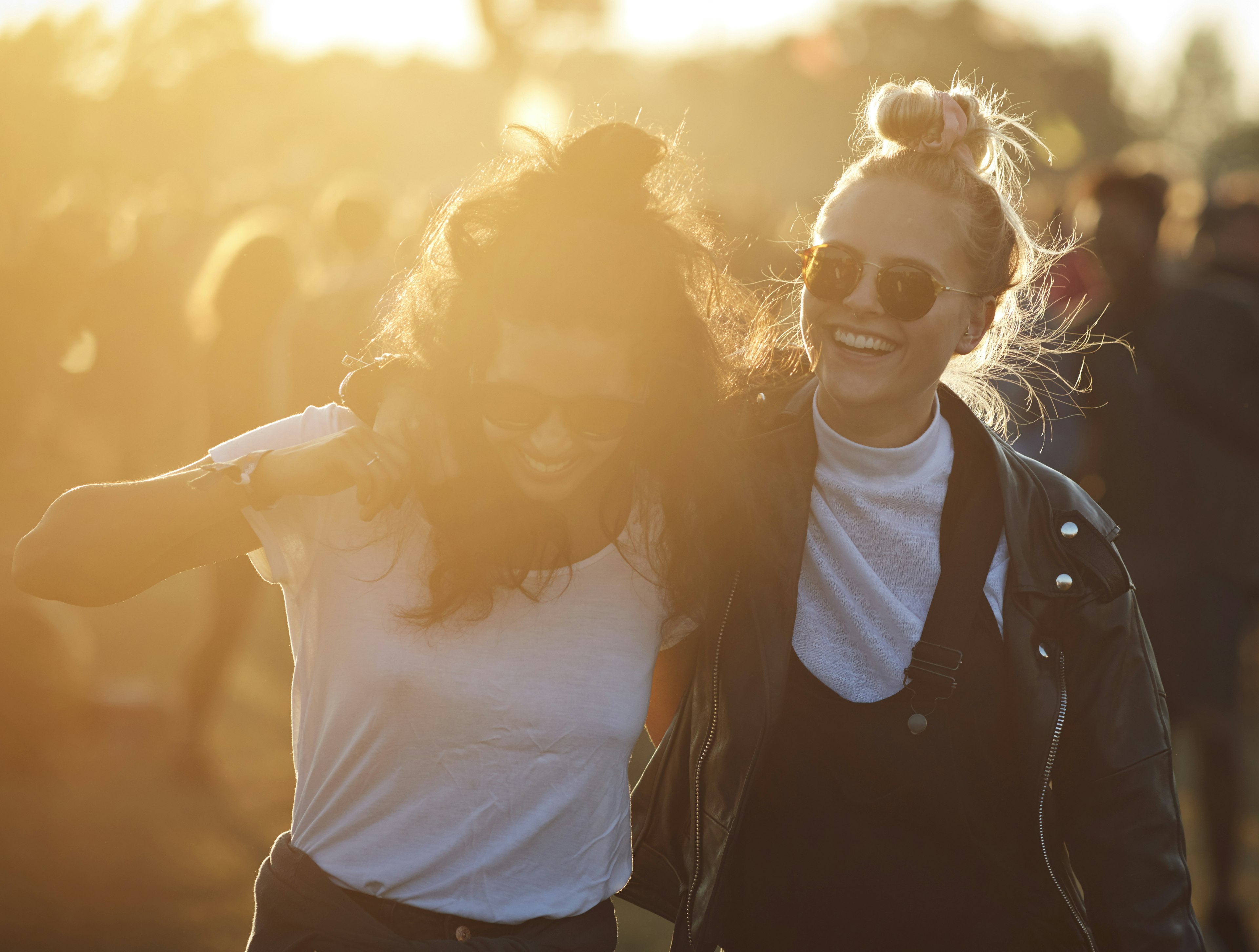 Friends laughing together at big festival in Denmark