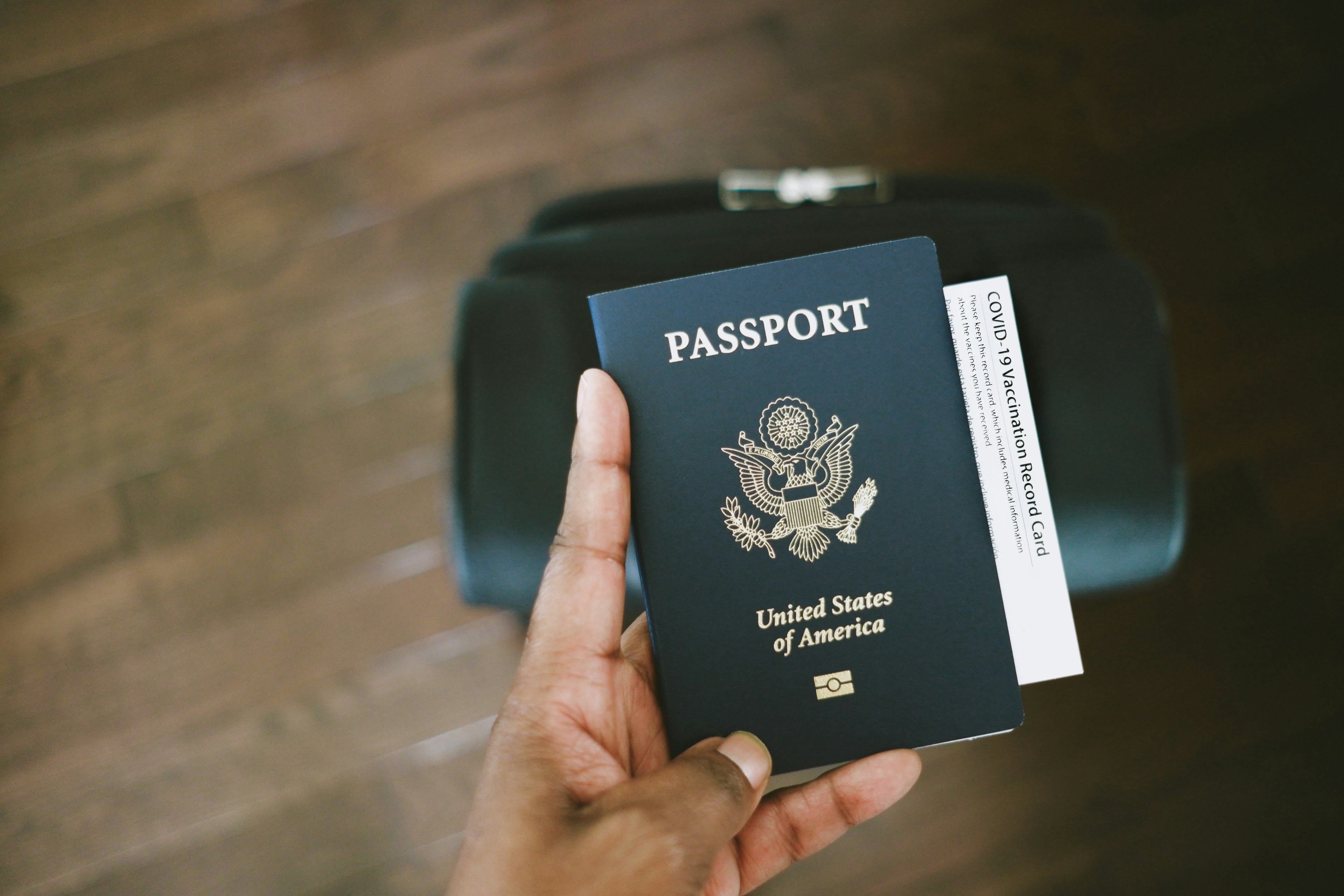 Woman Holds US Passport With COVID-19 Vaccination Card