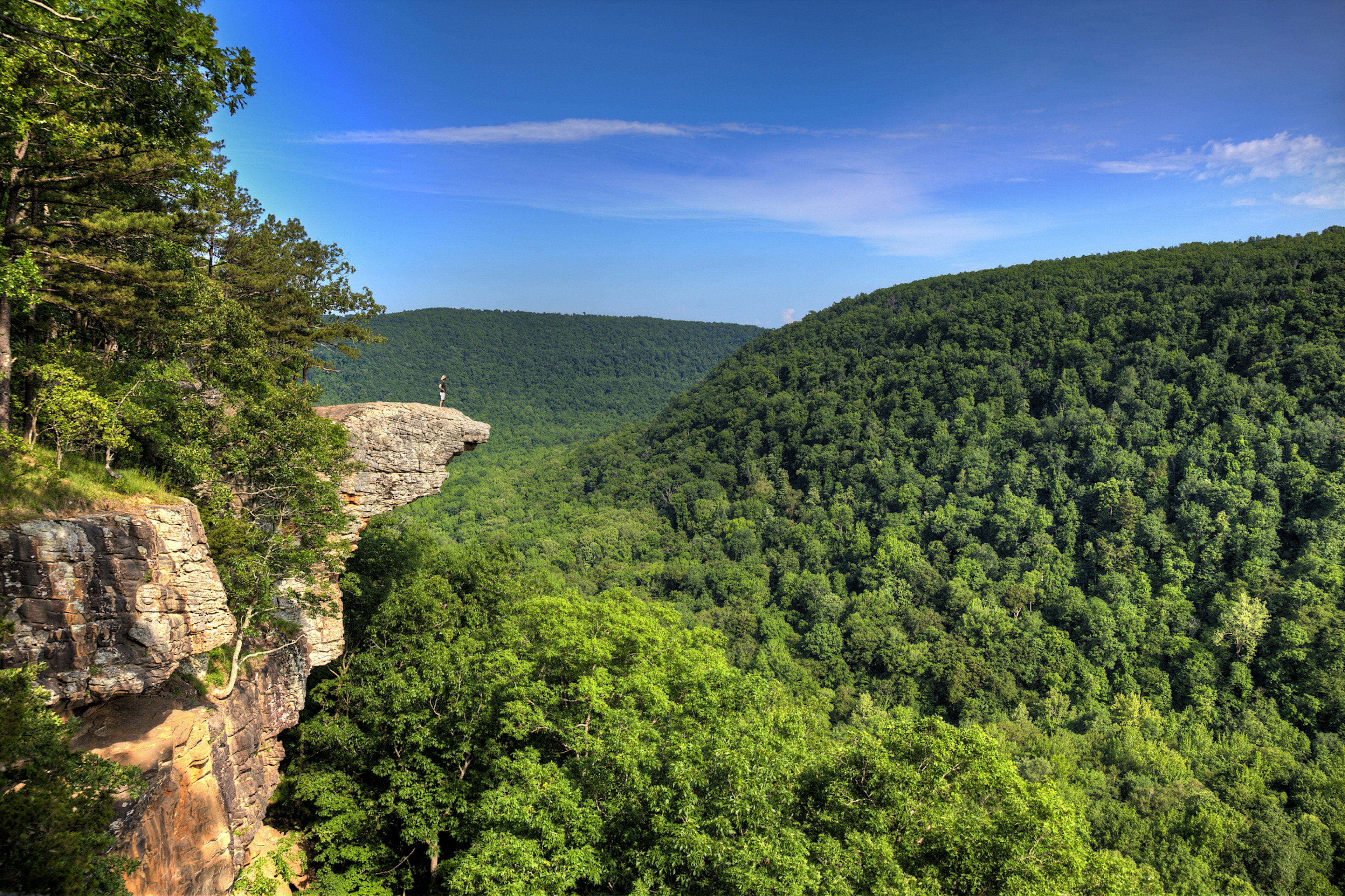 A person standing on the famed rocky outcrop on Whitaker's Point trail in the Ozarks, Arkansas