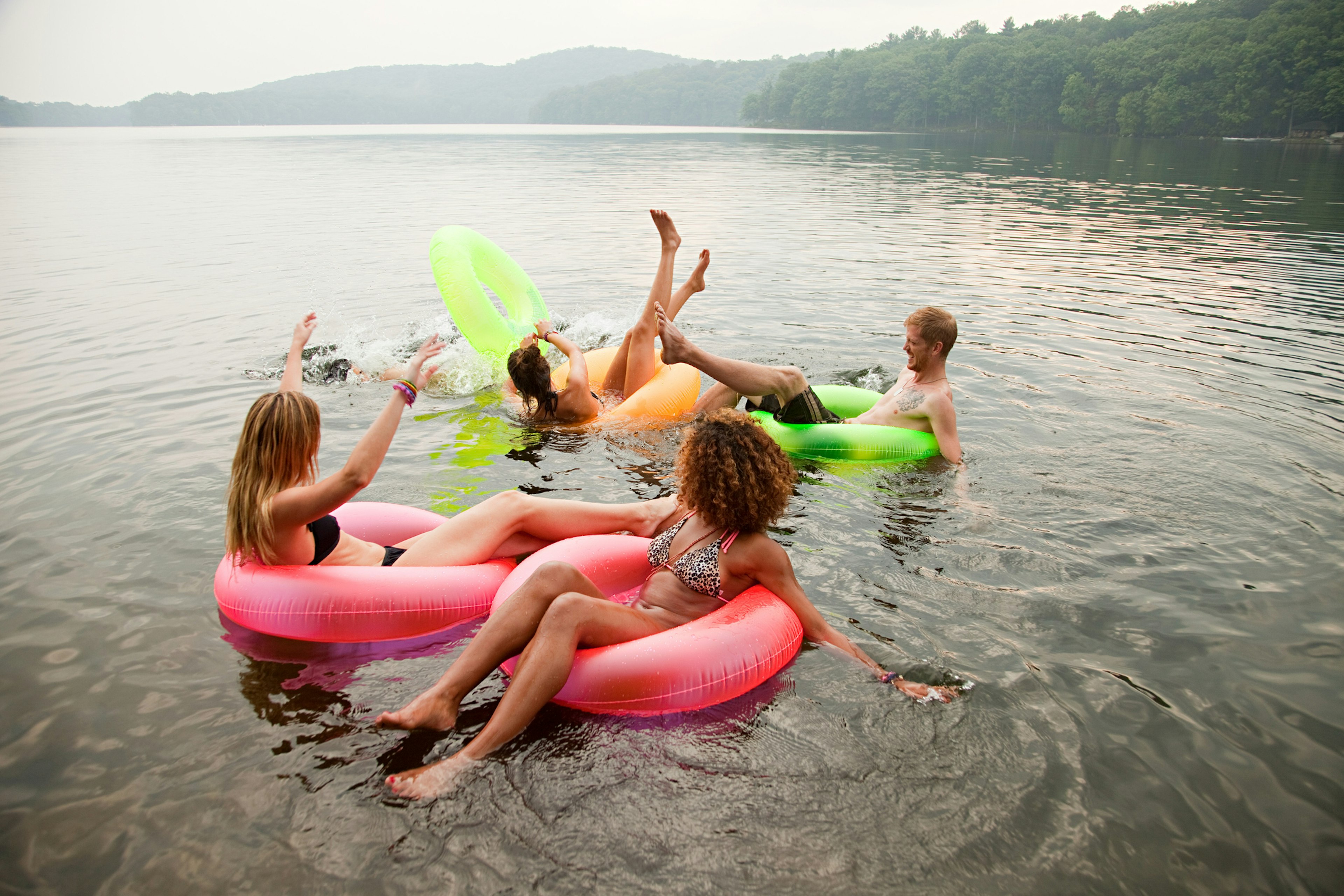 Friends in inflatables in the lake at Bear Mountain