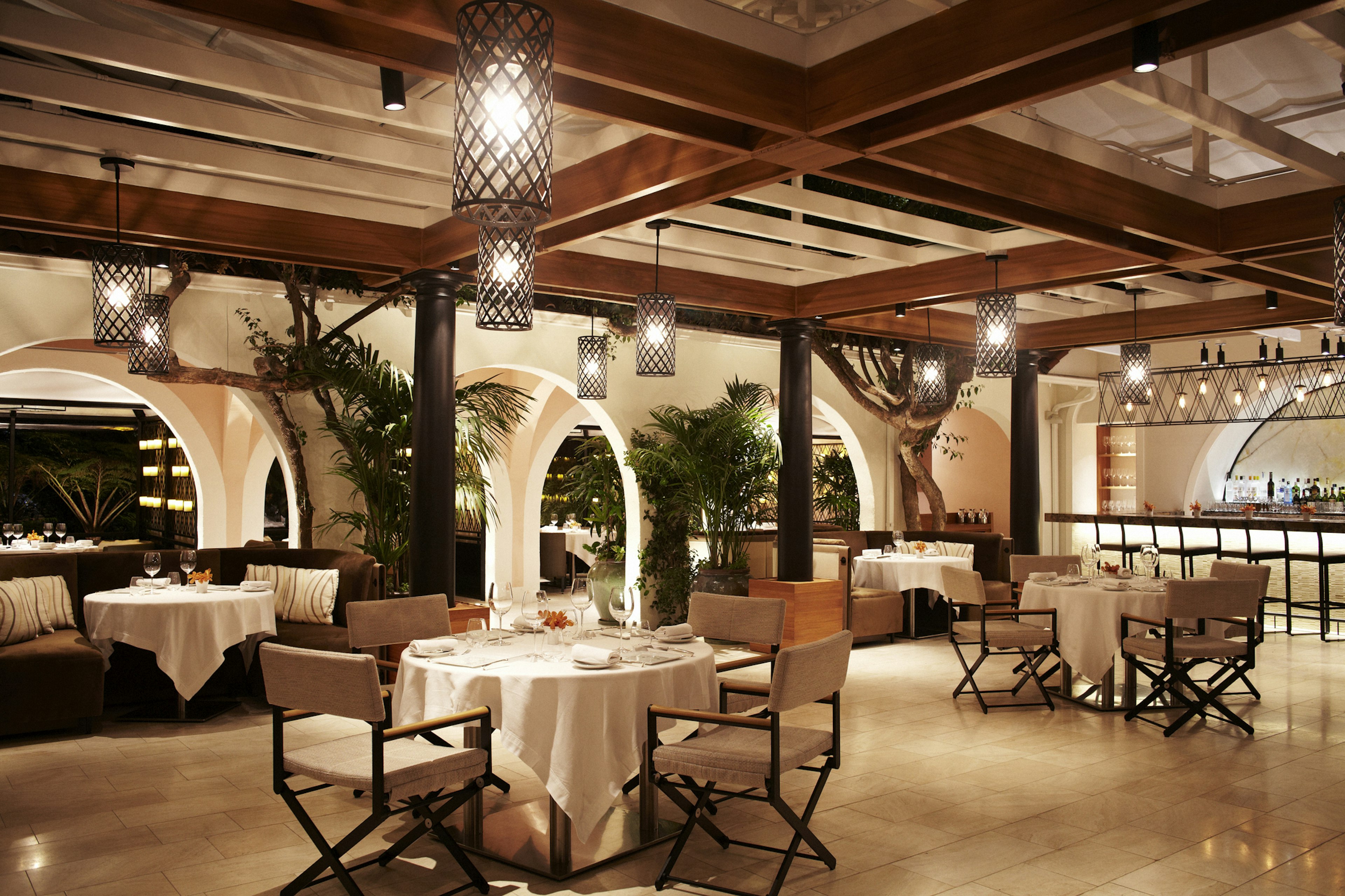 The interior of the Wolfgang Puck restaurant at the Hotel Bel-Air with a view out to the garden terrace