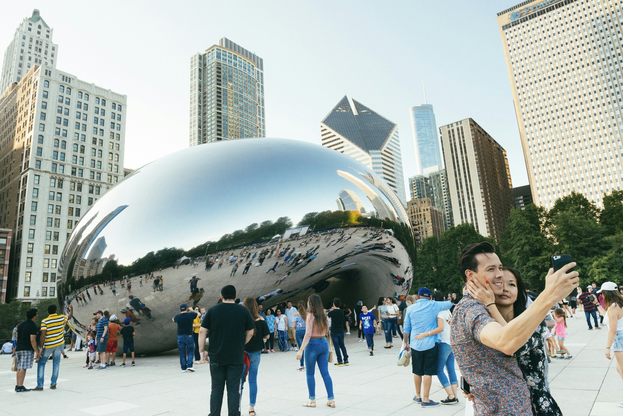 Crowds pose around the famous Cloudgate sculpture in Millennium Park