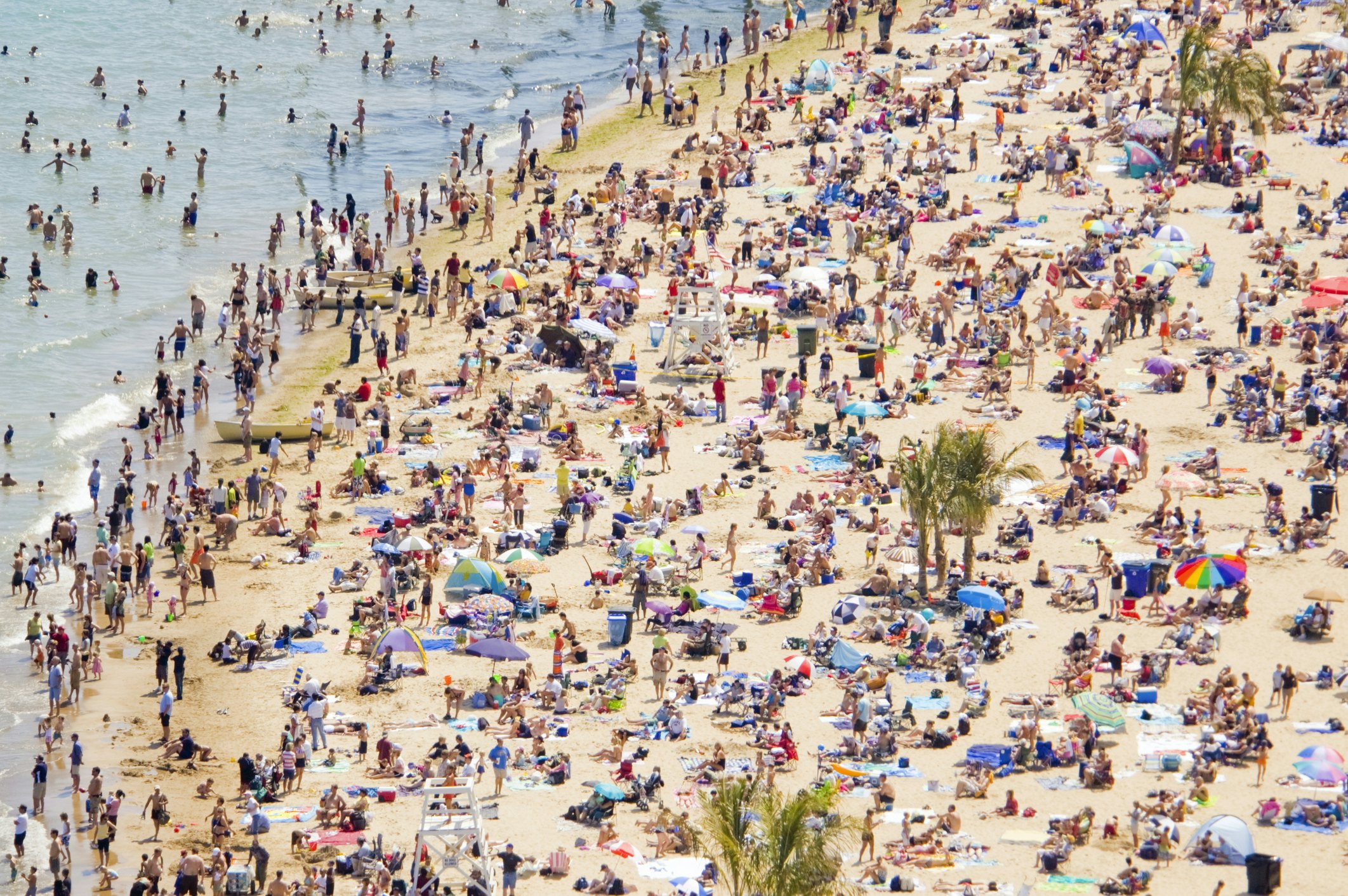 Busy crowds on Chicago's Oak Street Beach in the summertime.