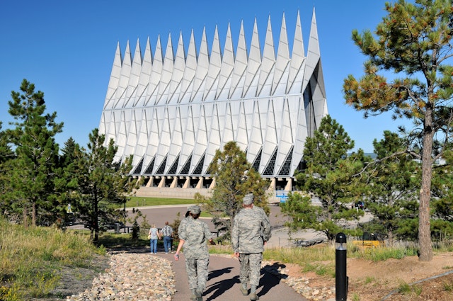 Cadets and servicemen walk toward the Cadet Chapel at the US Air Force Academy, Colorado Springs, Colorado, USA