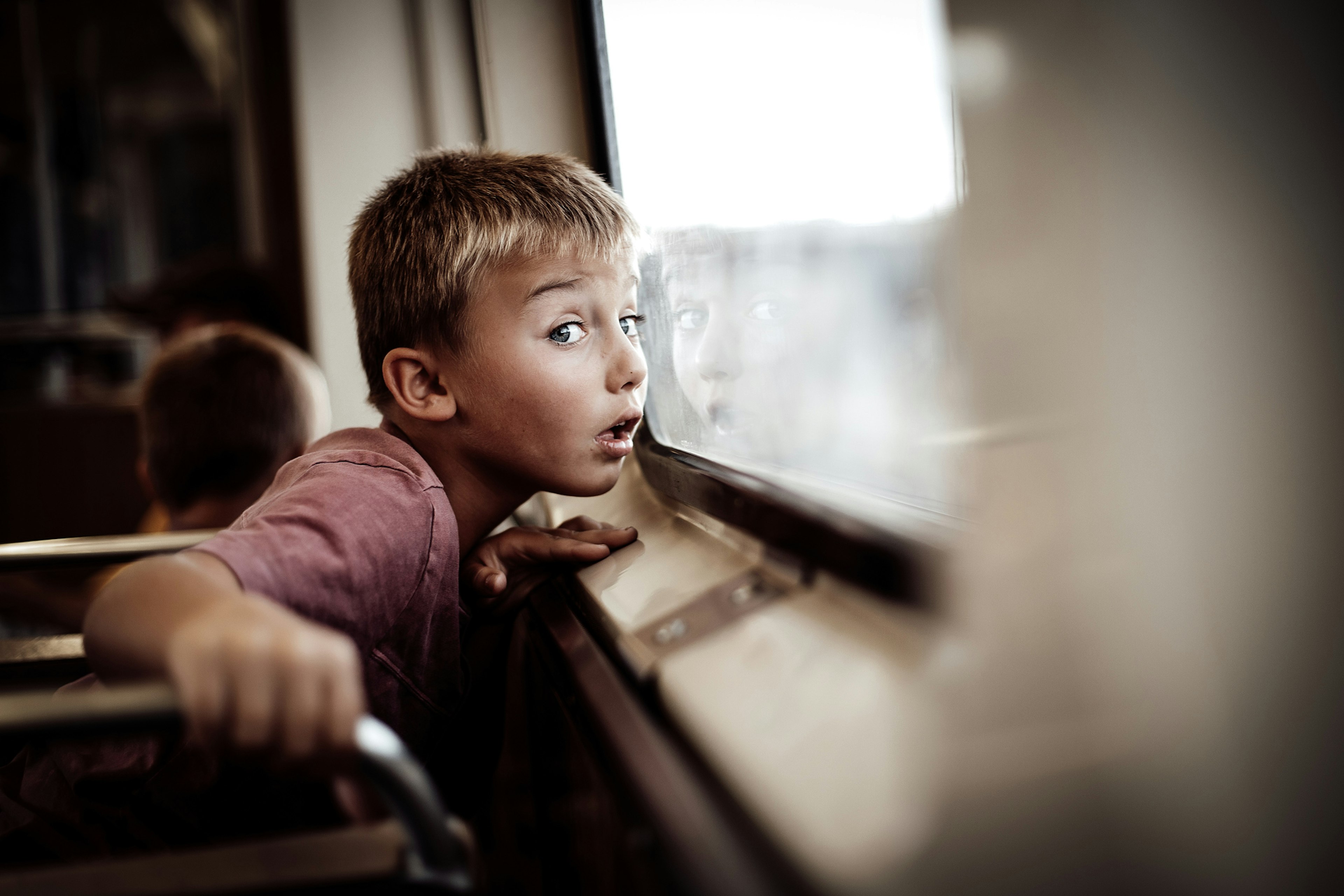 A little boy looks out of the window of a train in Chicago, United States