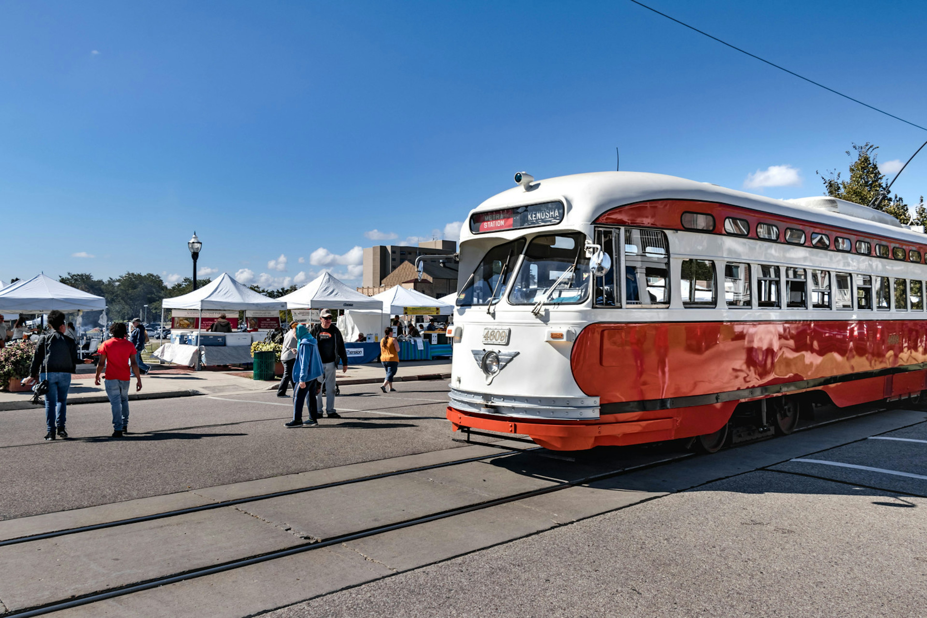 An electric streetcar going by Kenosha HarborMarket