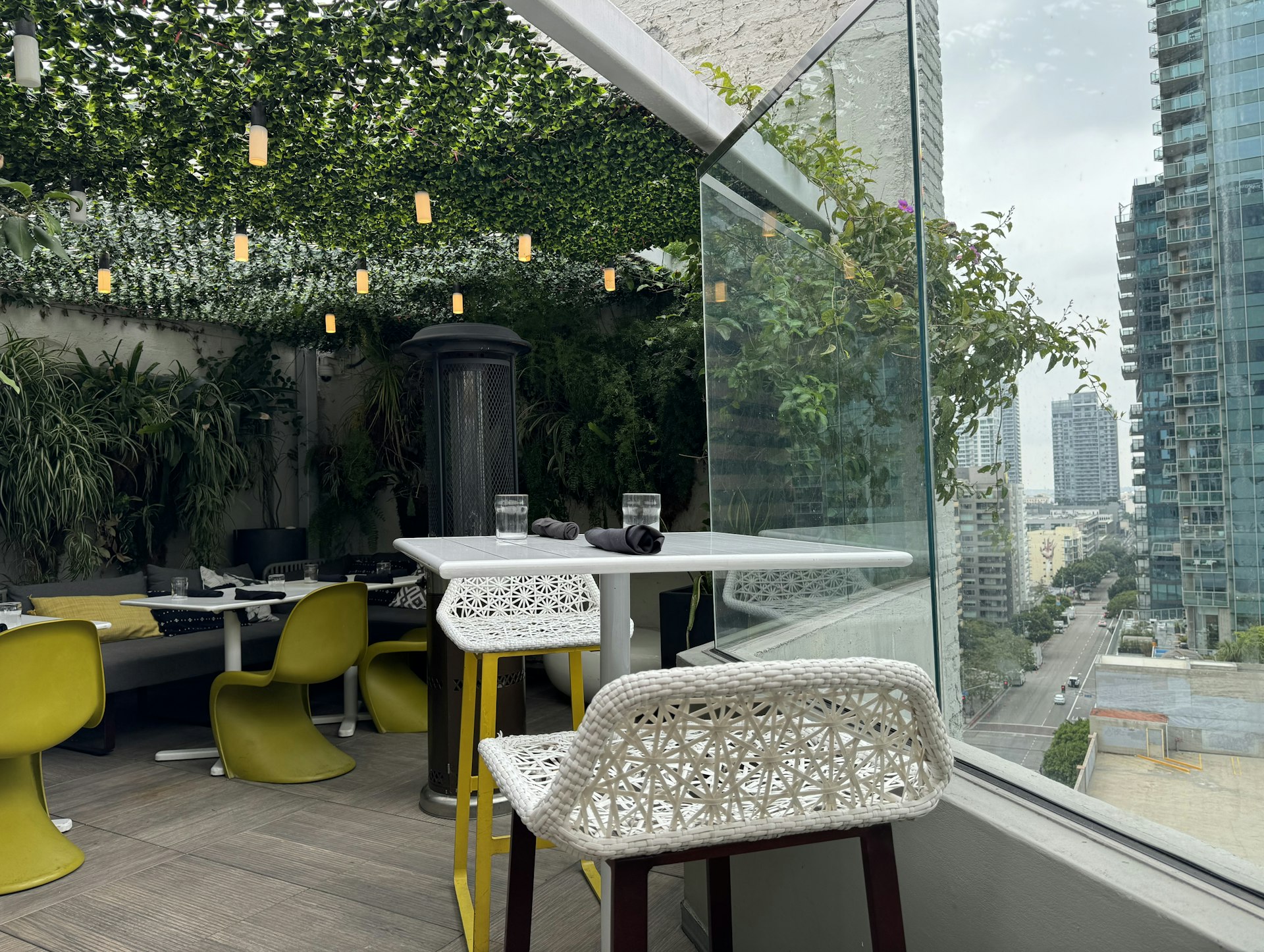 A view of the outdoor rooftop bar at The Wayfarer DTLA in Los Angeles.