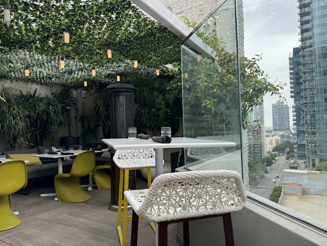A view of the outdoor rooftop bar at The Wayfarer DTLA in Los Angeles.