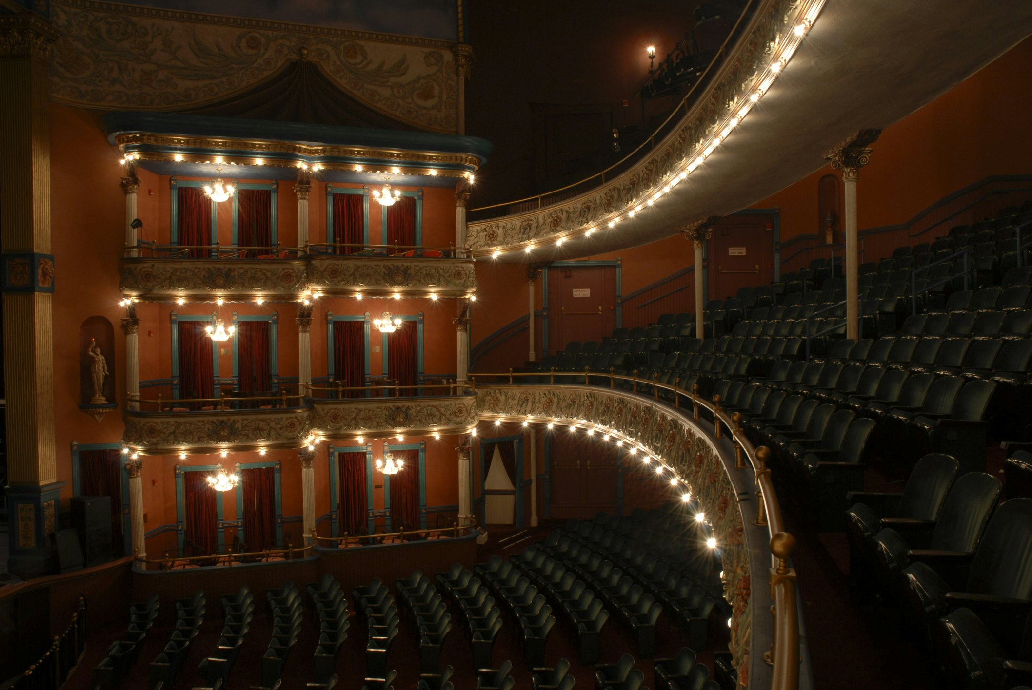 Interior of an empty opera house with curved balcony seating