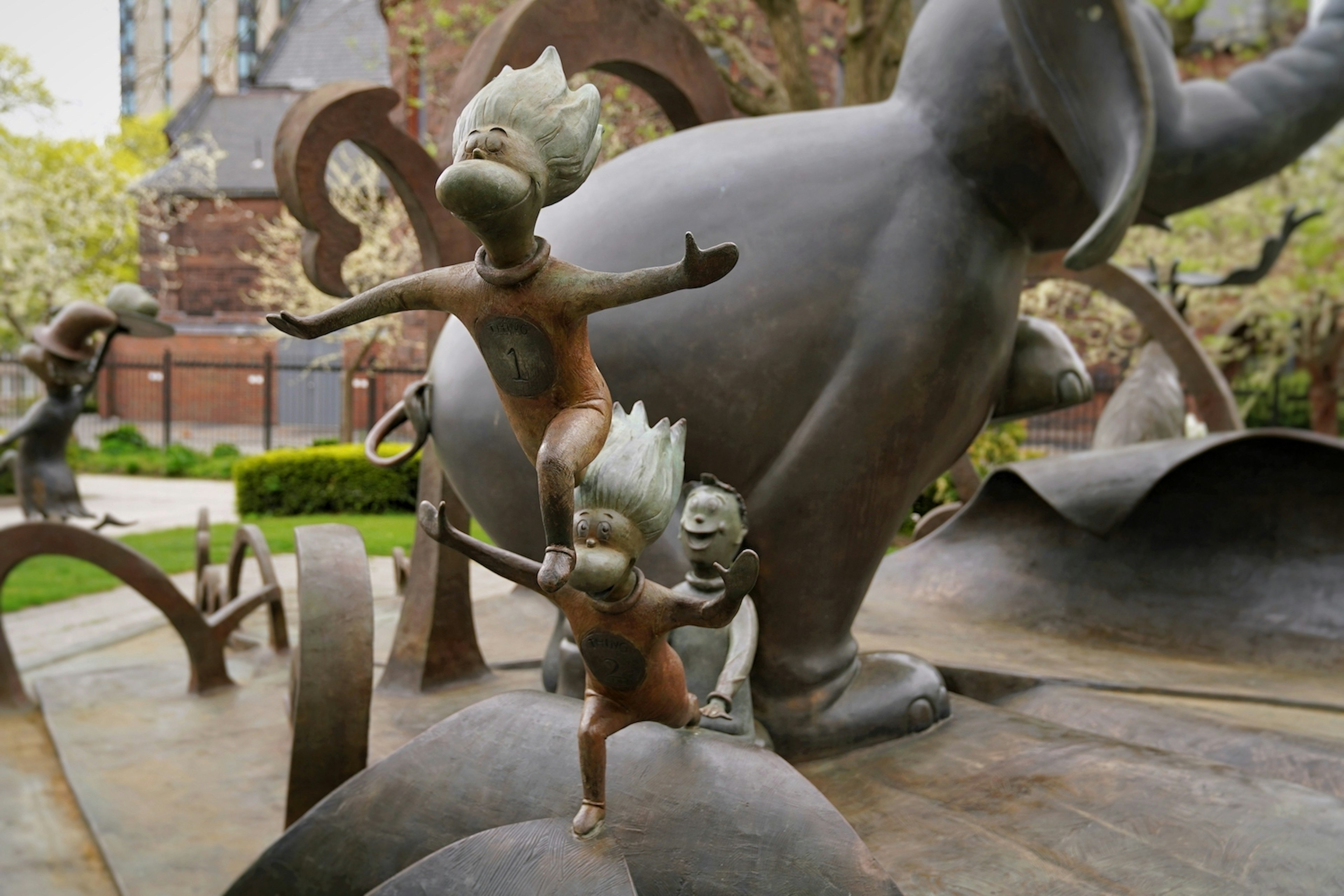 Thing 1 and Thing 2 are jumping out in a sculpture group at the Dr Seuss National Memorial Sculpture Garden, Springfield, Massachusetts, New England, USA