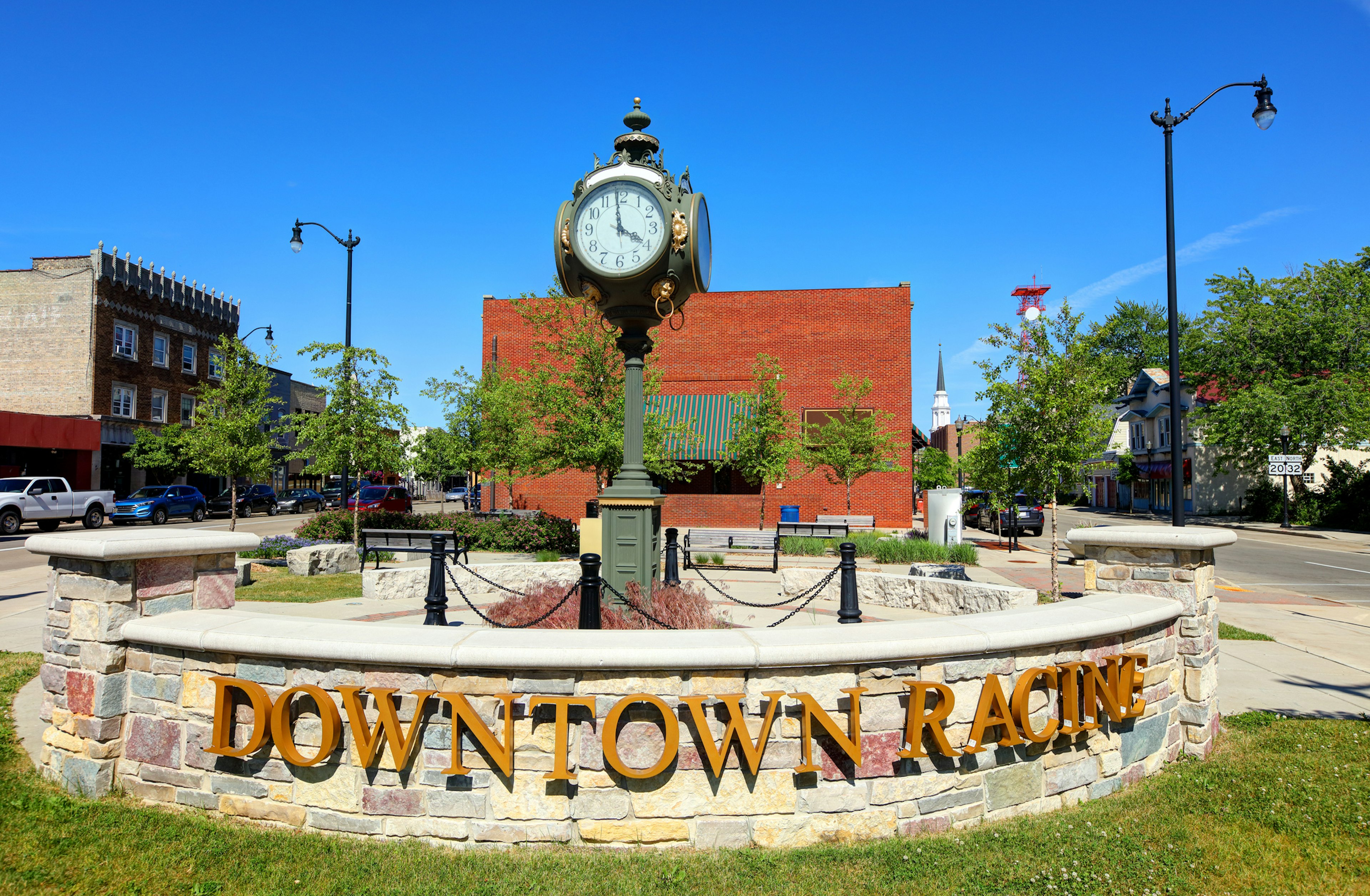 A sign that reads Downtown Racine in front of a small clock tower in Racine, Wisconsin