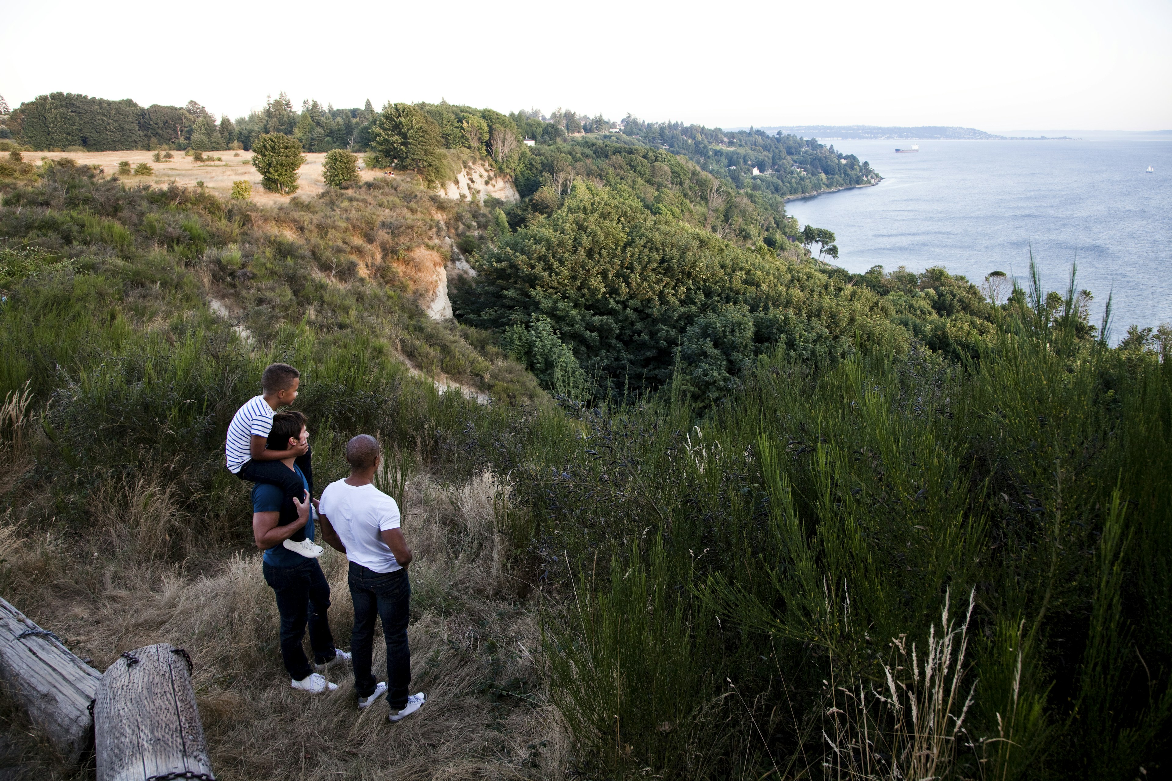 People standing on rocks and looking at the sea