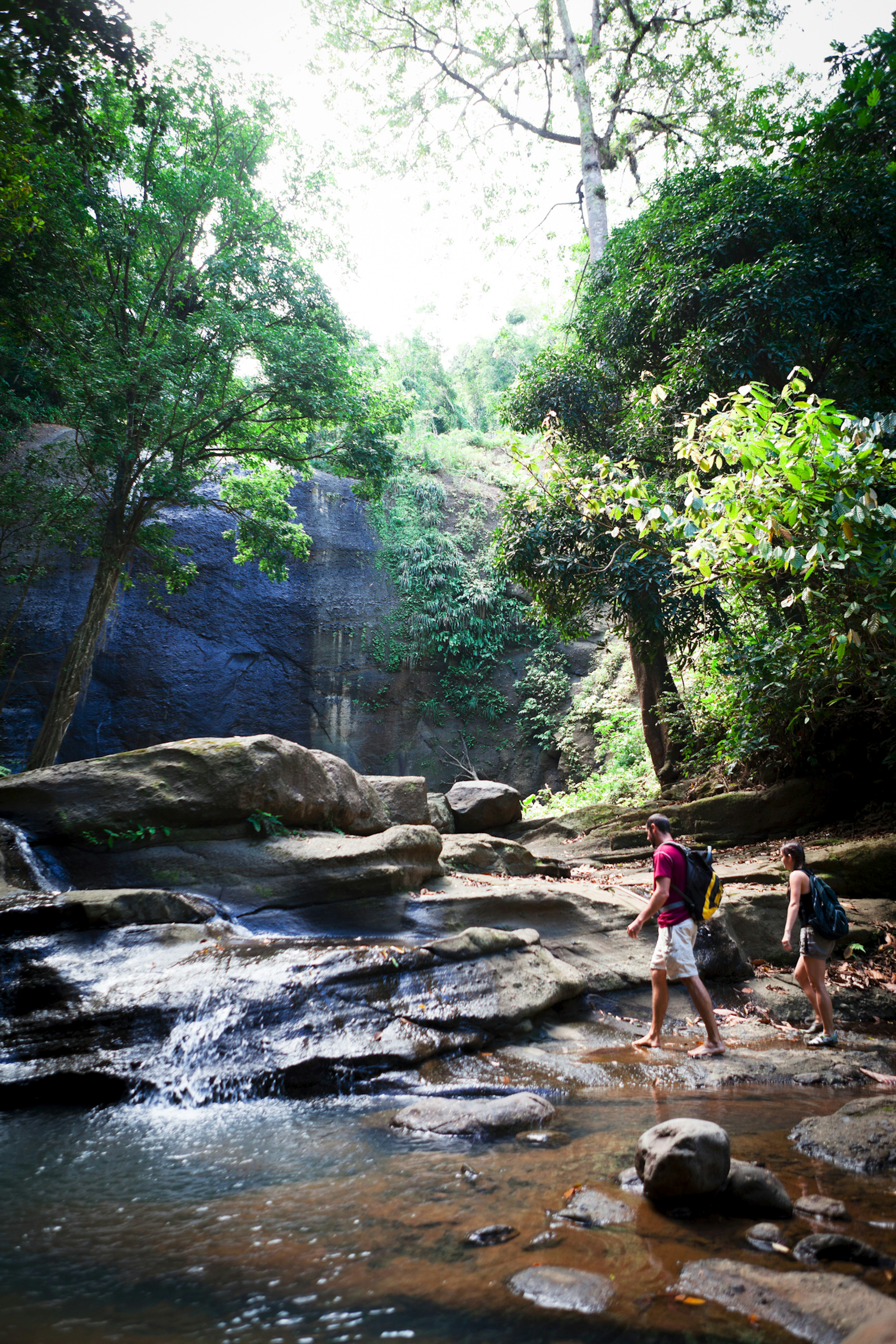 Young Man and Woman Hiking a Tropical River