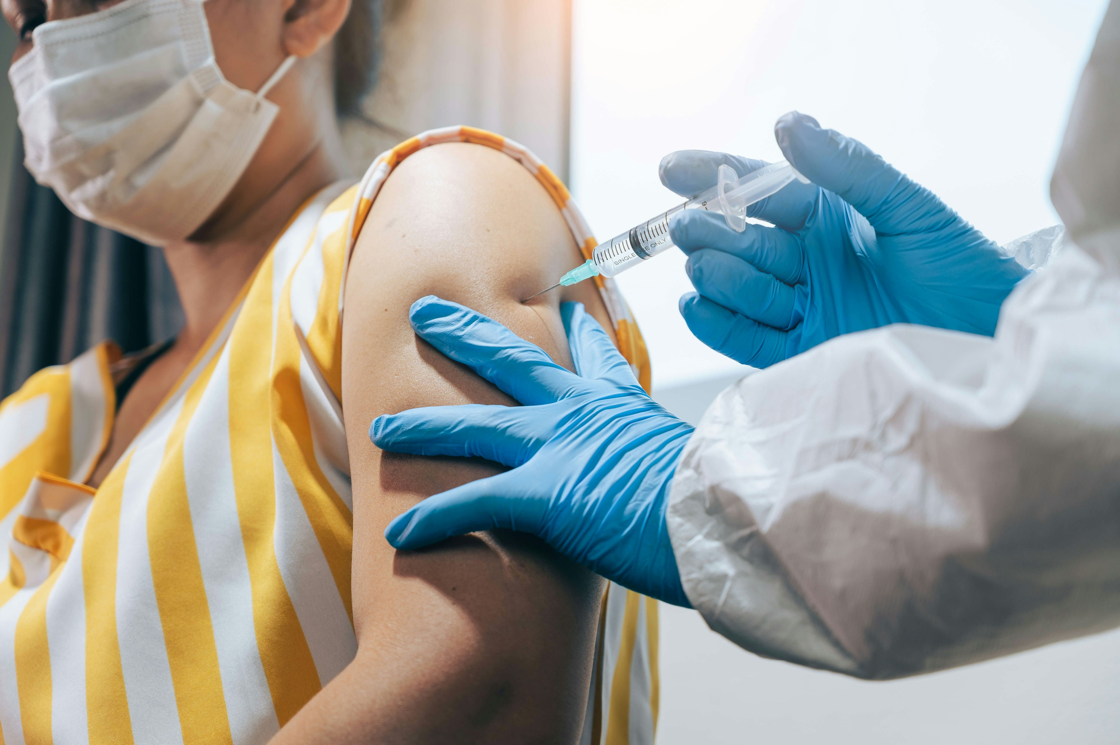 A woman gets injected with the COVID-19 vaccine.