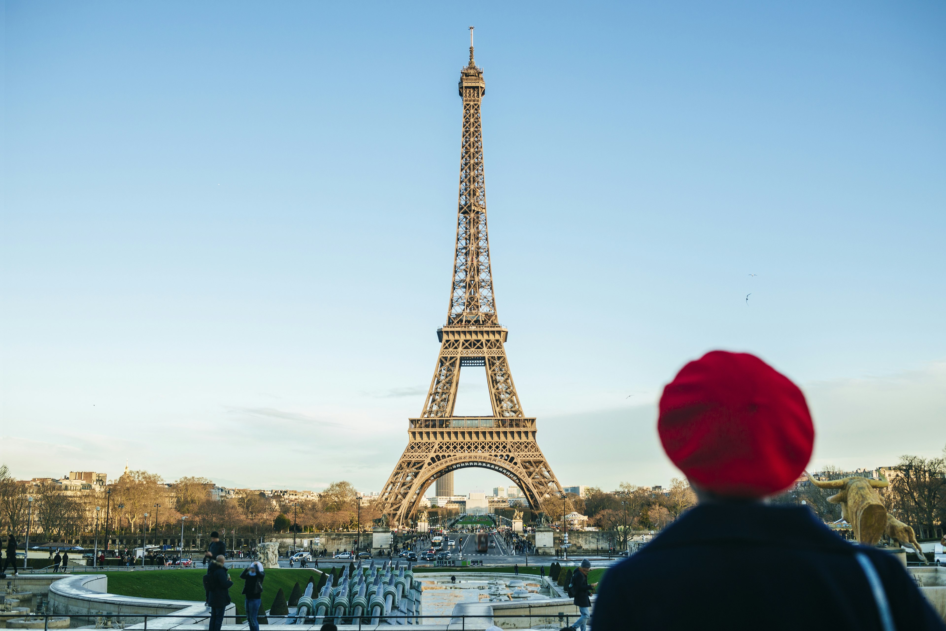 View to Eiffel Tower with back view of young woman standing in the foreground