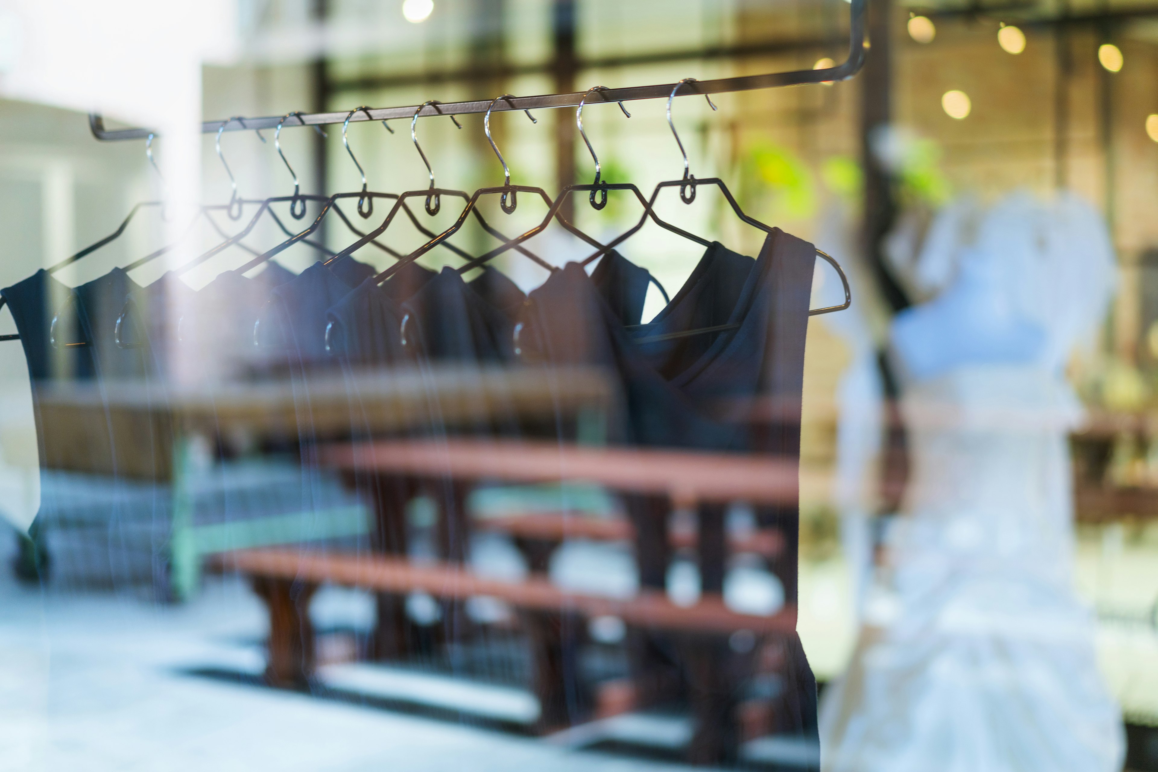 Black dresses arranged on clothes rack