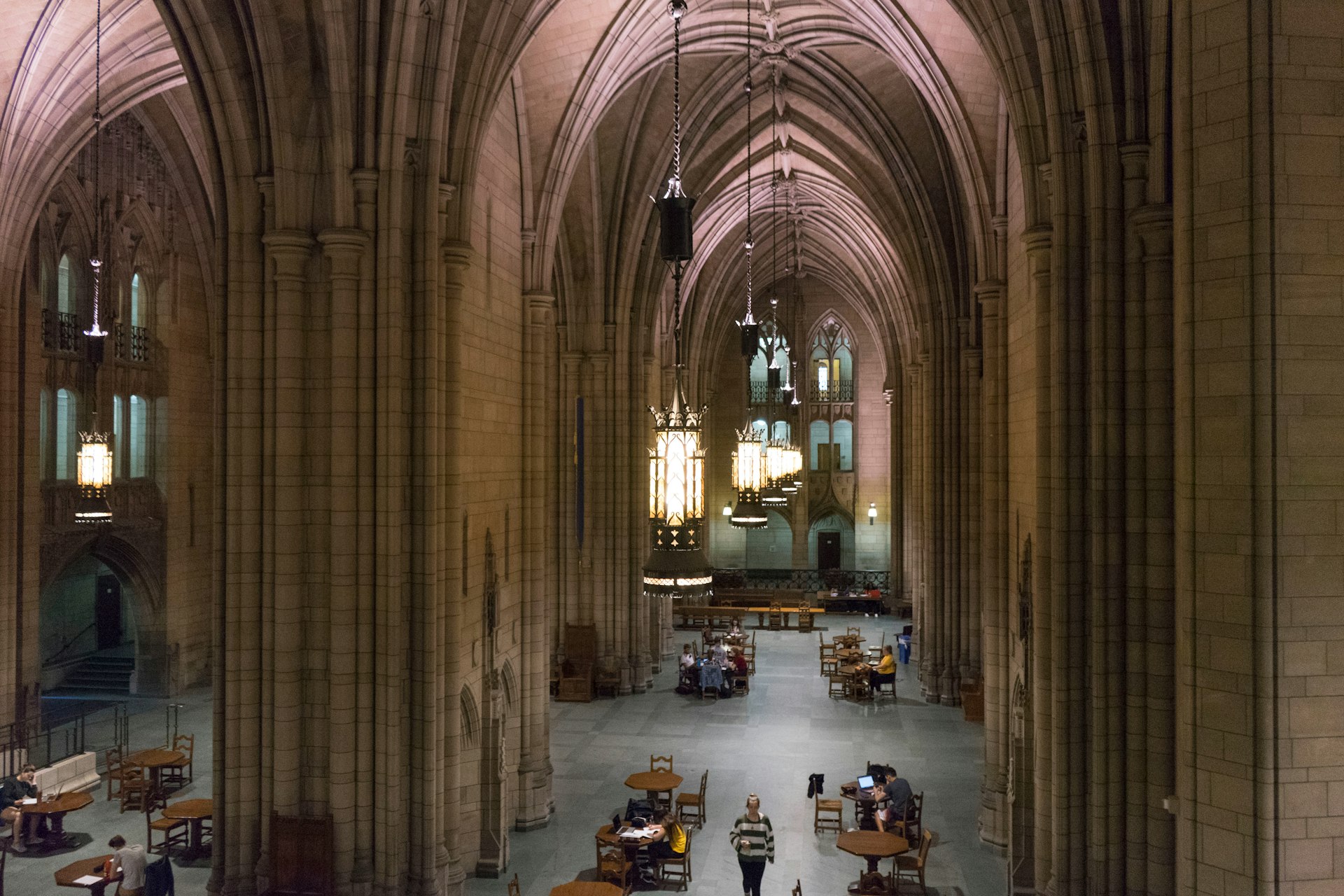 People studying and reading in a soaring space in the neo-Gothic Cathedral of Learning at the University of Pittsburgh