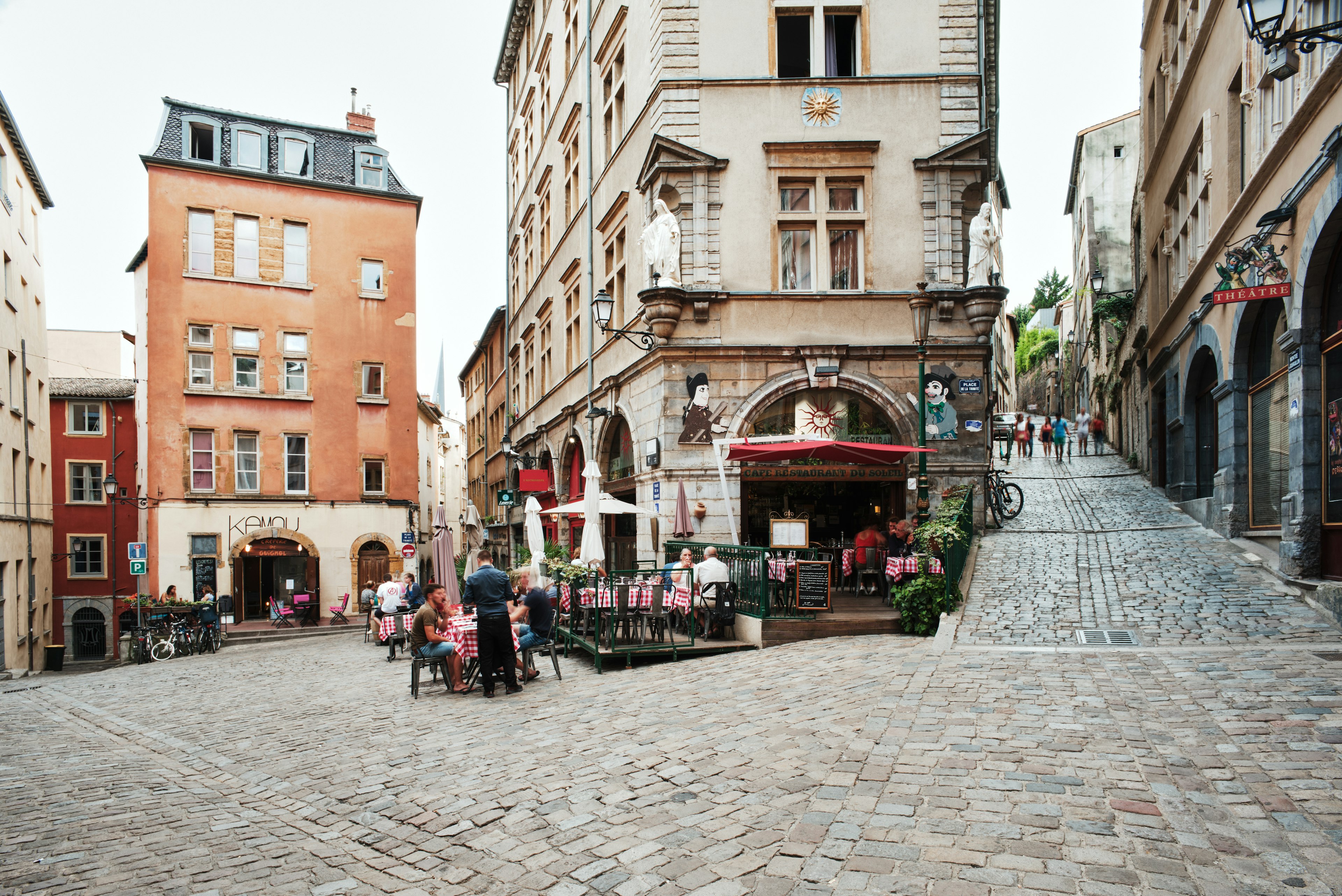 People dining outside in the early evening at restaurants in Lyon