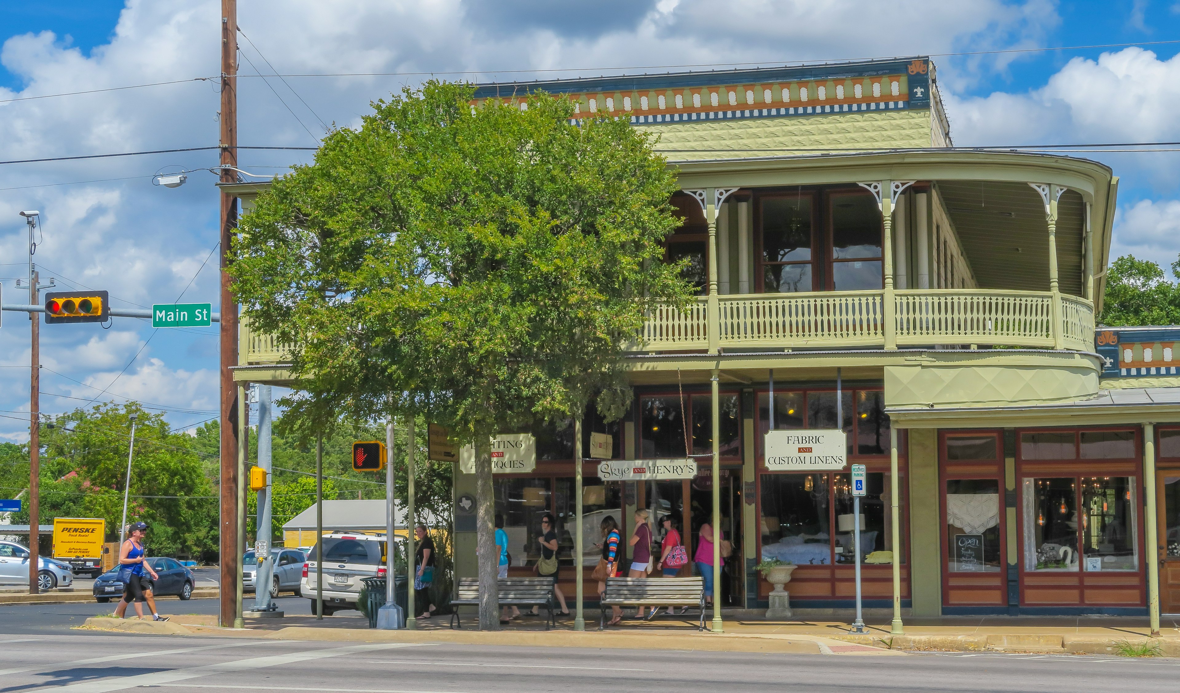 A corner building with balconies in a town