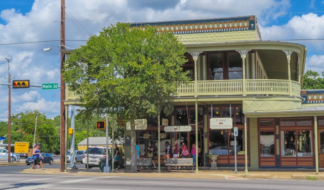 A corner building with balconies in a town