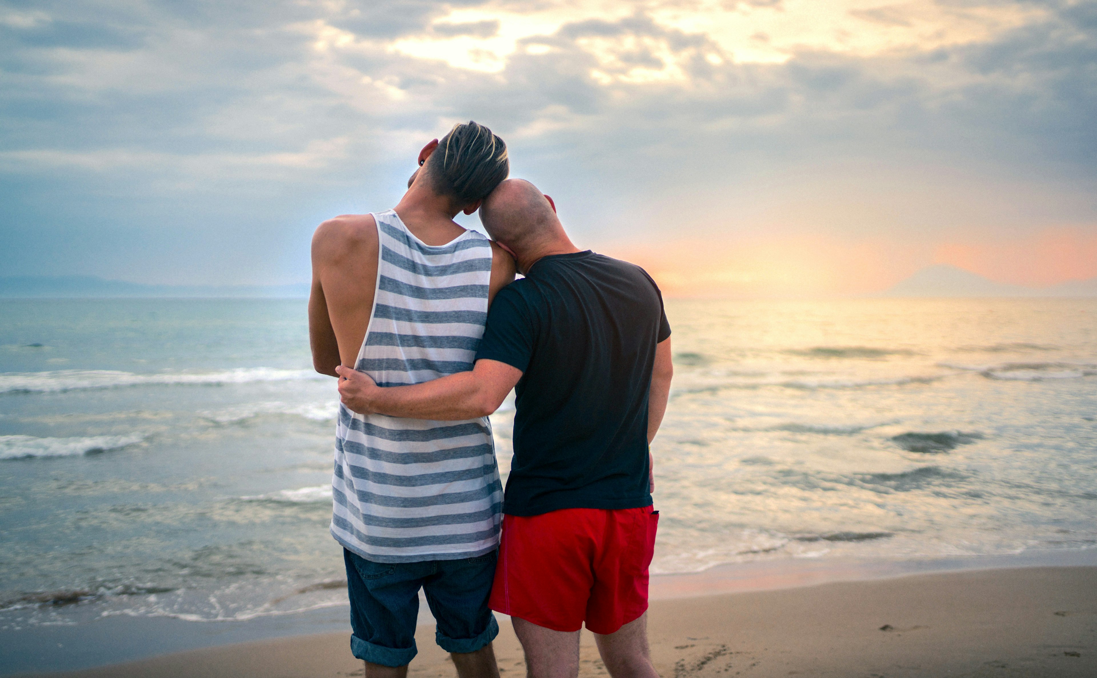 Homosexual couple watching the sunset at Mykonos