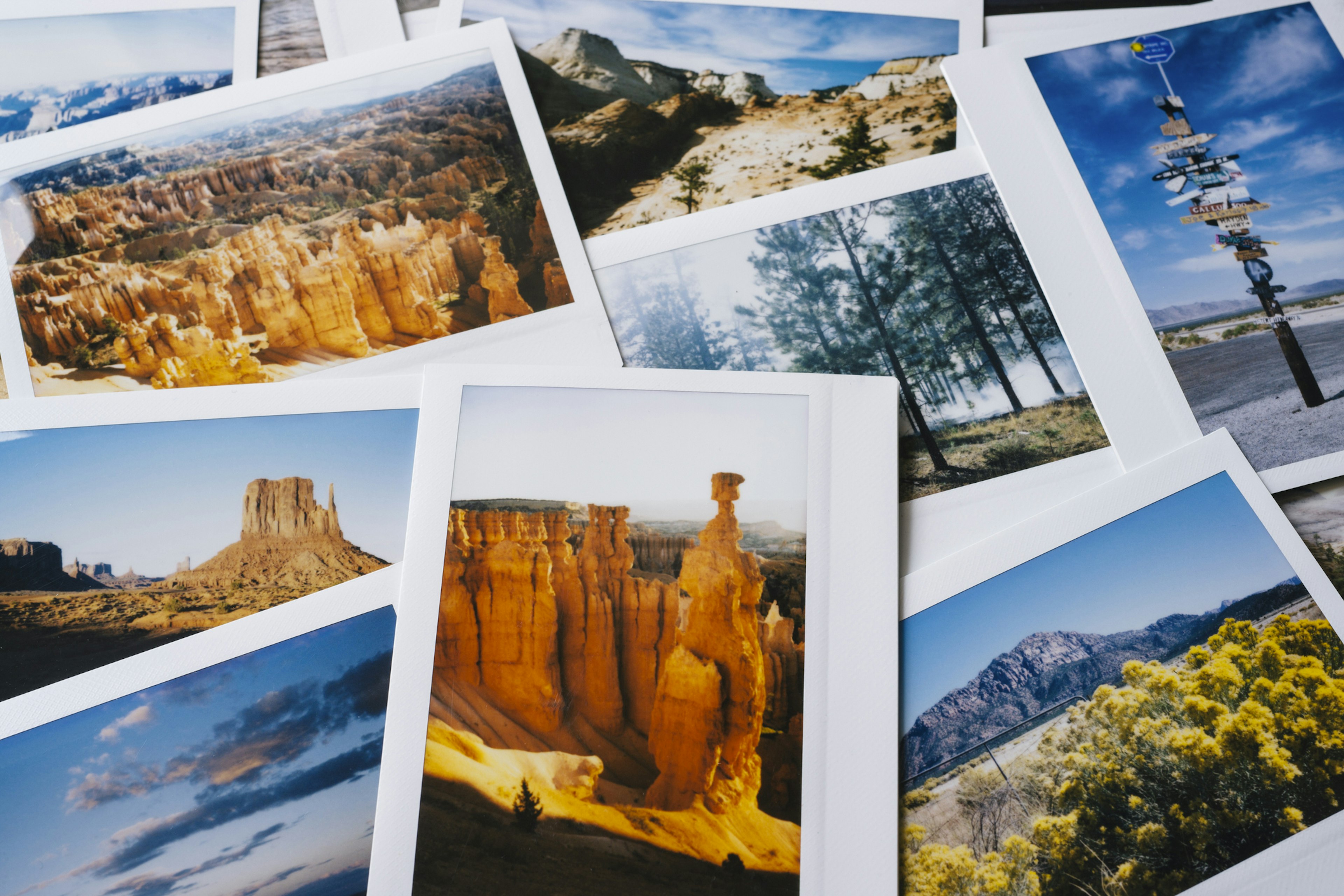 Collection of instant travel holiday photos on a table