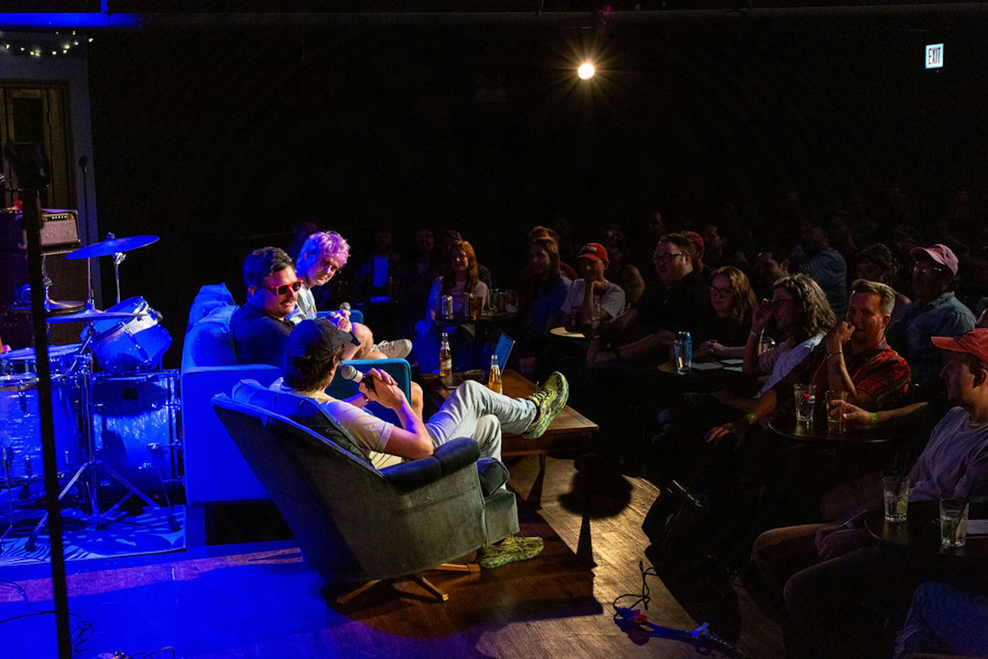 An audience watches a seated panel of performers at the iO improv theater