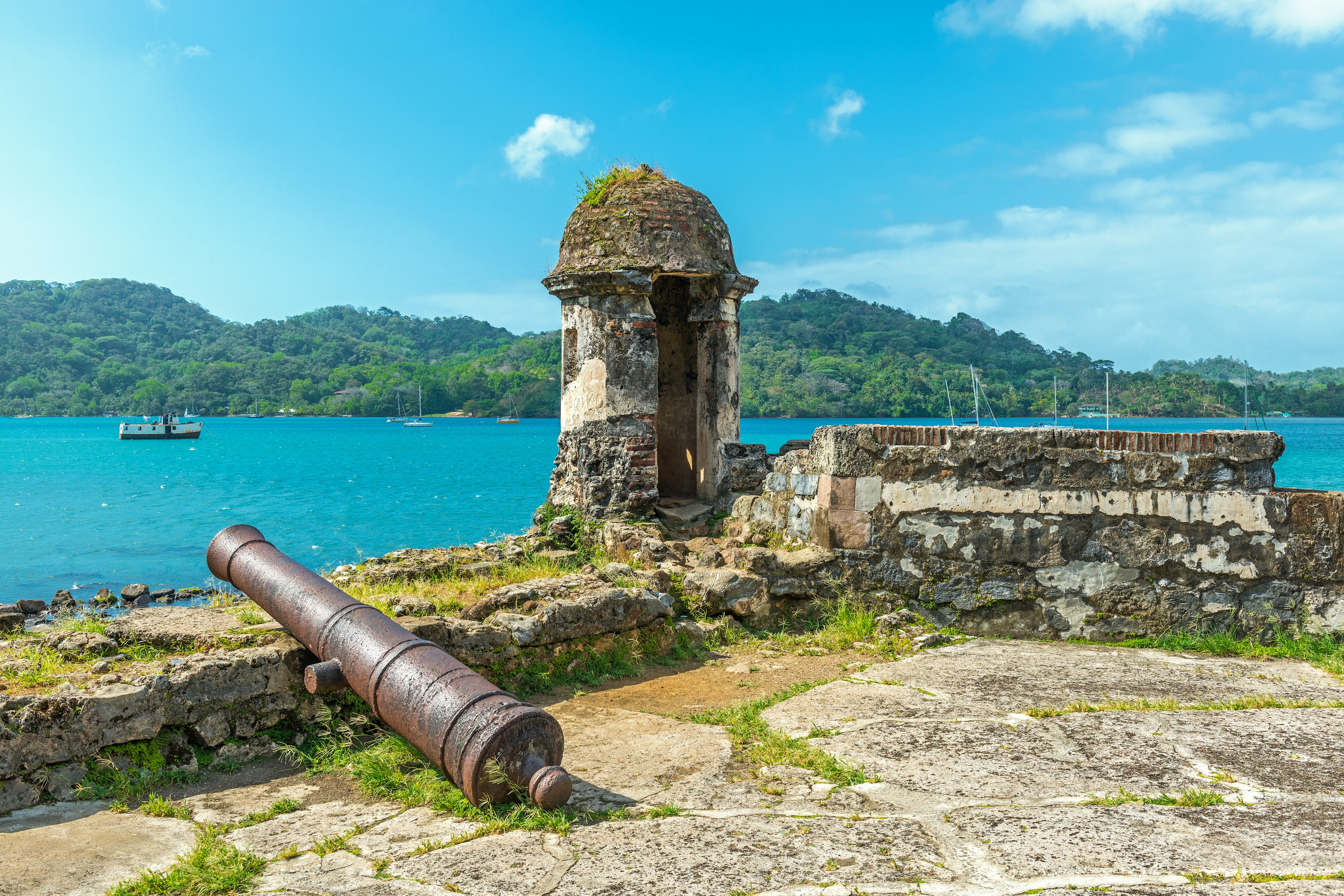 Old Spanish cannon at the fortress ruin of Santiago with a view over the Caribbean Sea in Portobelo near Colon, Panama, Central America.