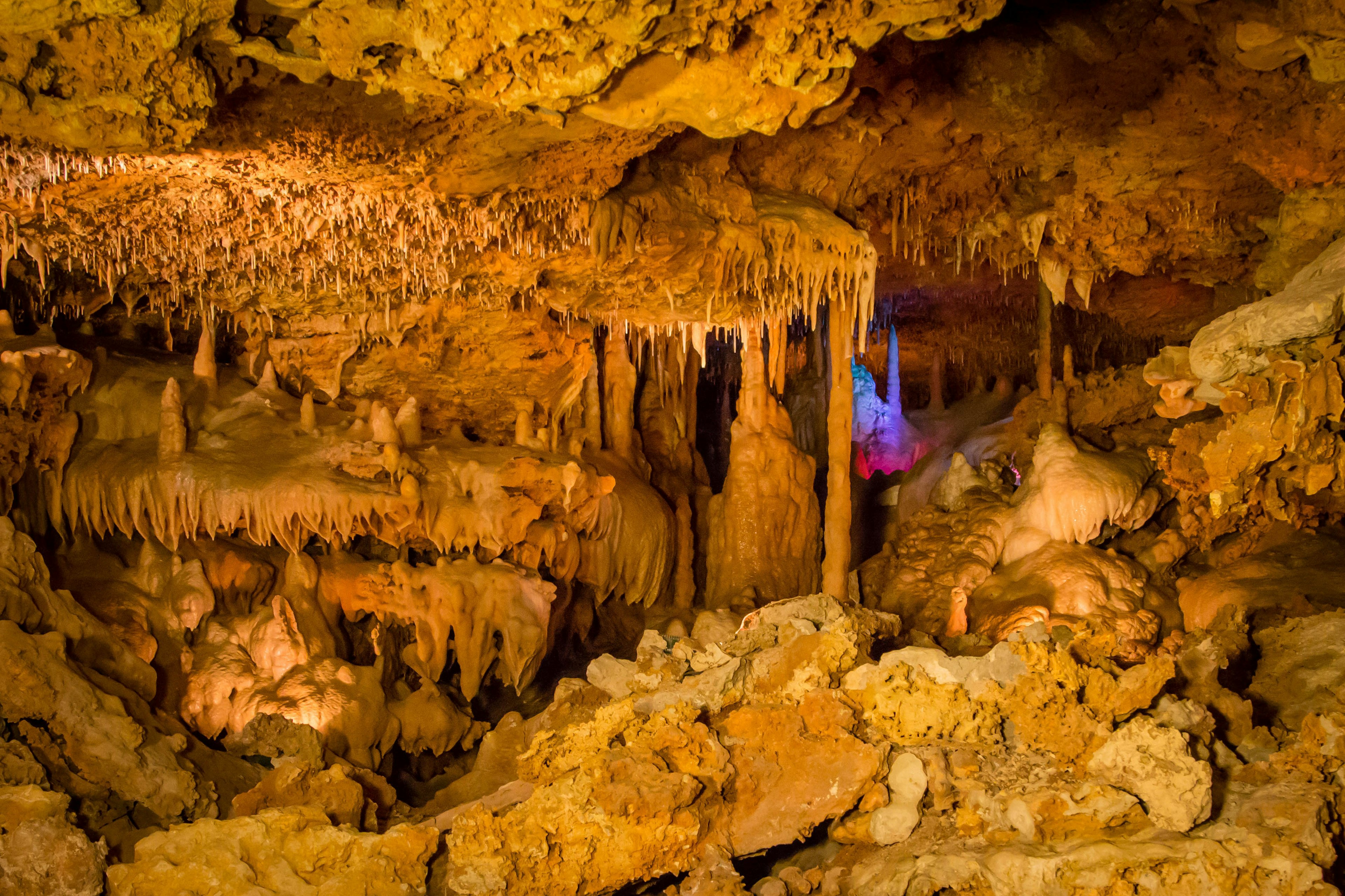 Lights show off a stalactite in the back of Inner Space Caverns