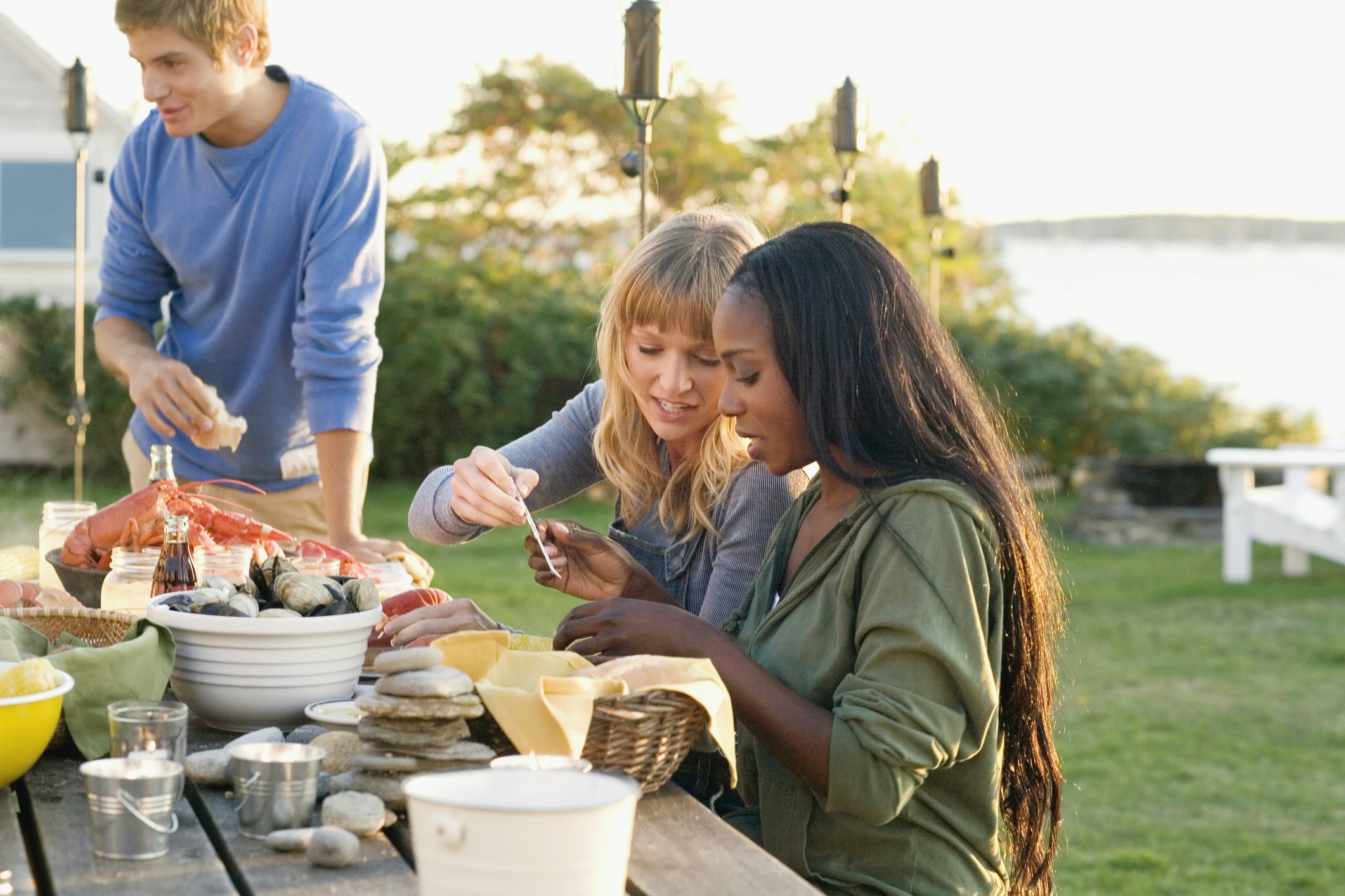 Friends sharing a seafood dinner outside