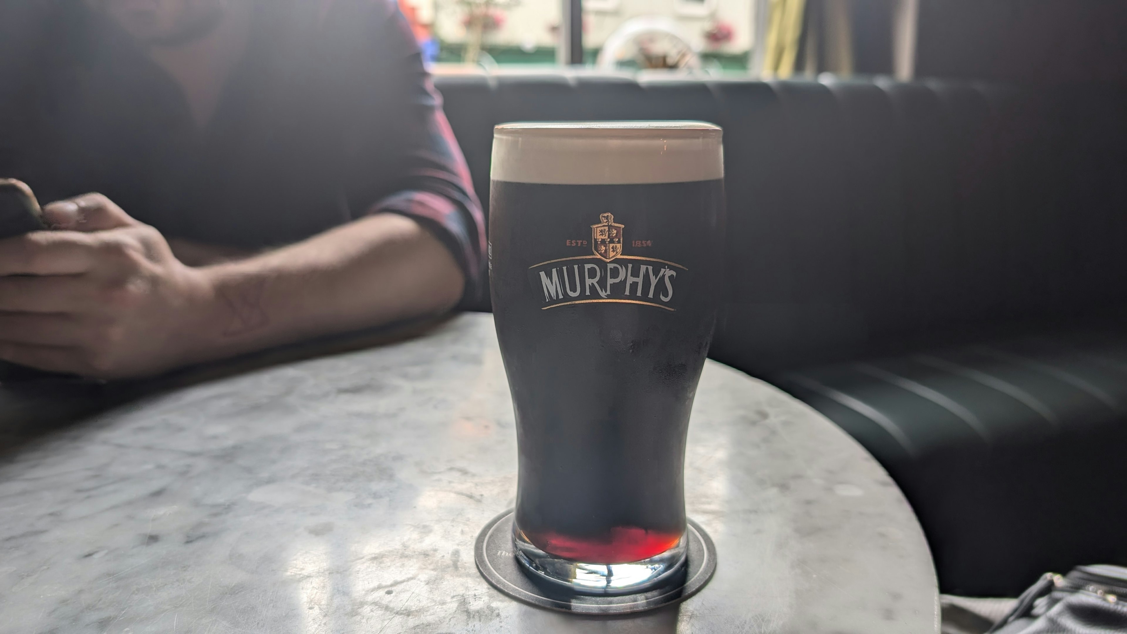 A pint of Murphy’s stout on a table at a pub