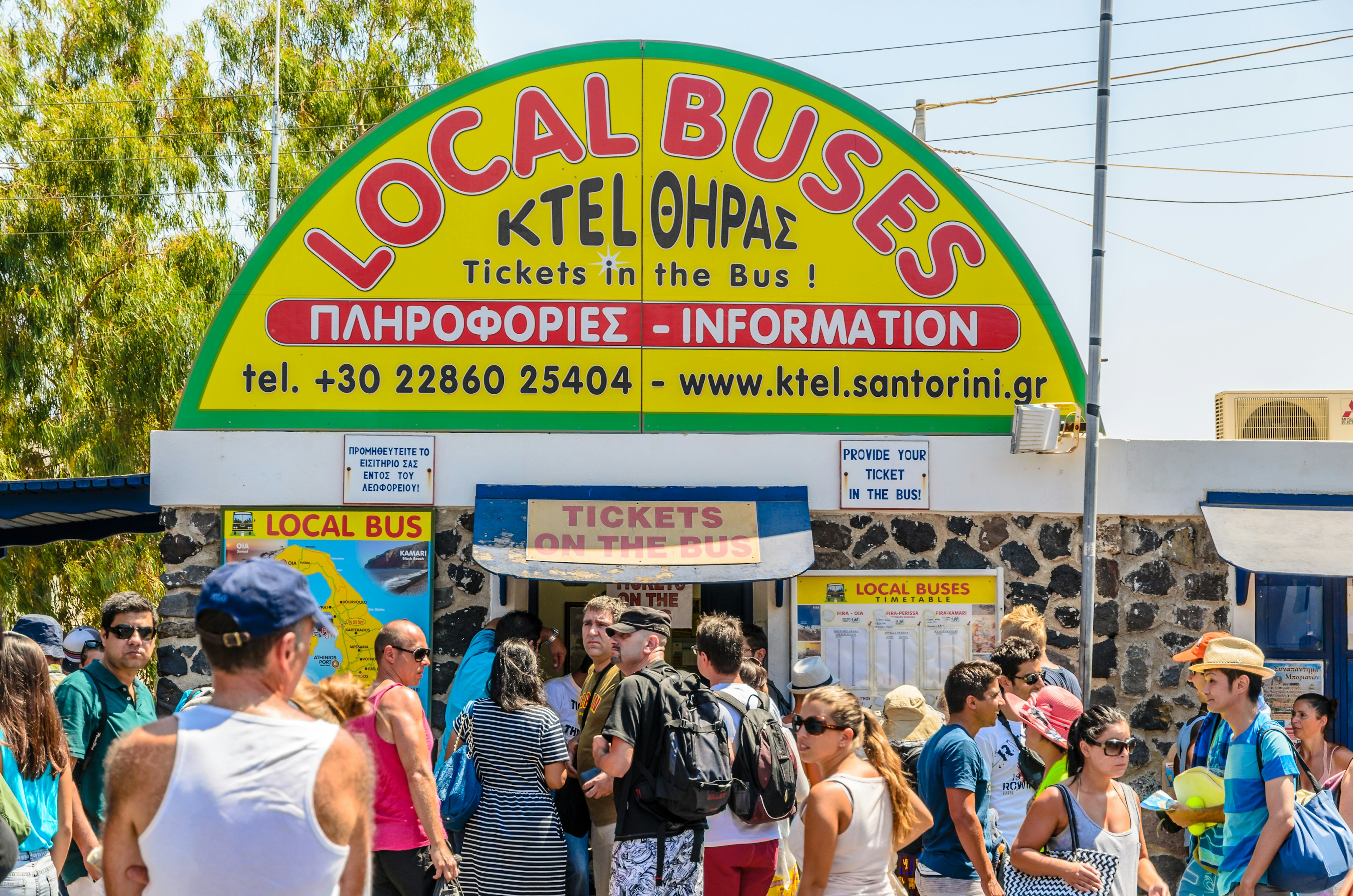 People crowd around the main bus station in Fira, Santorini