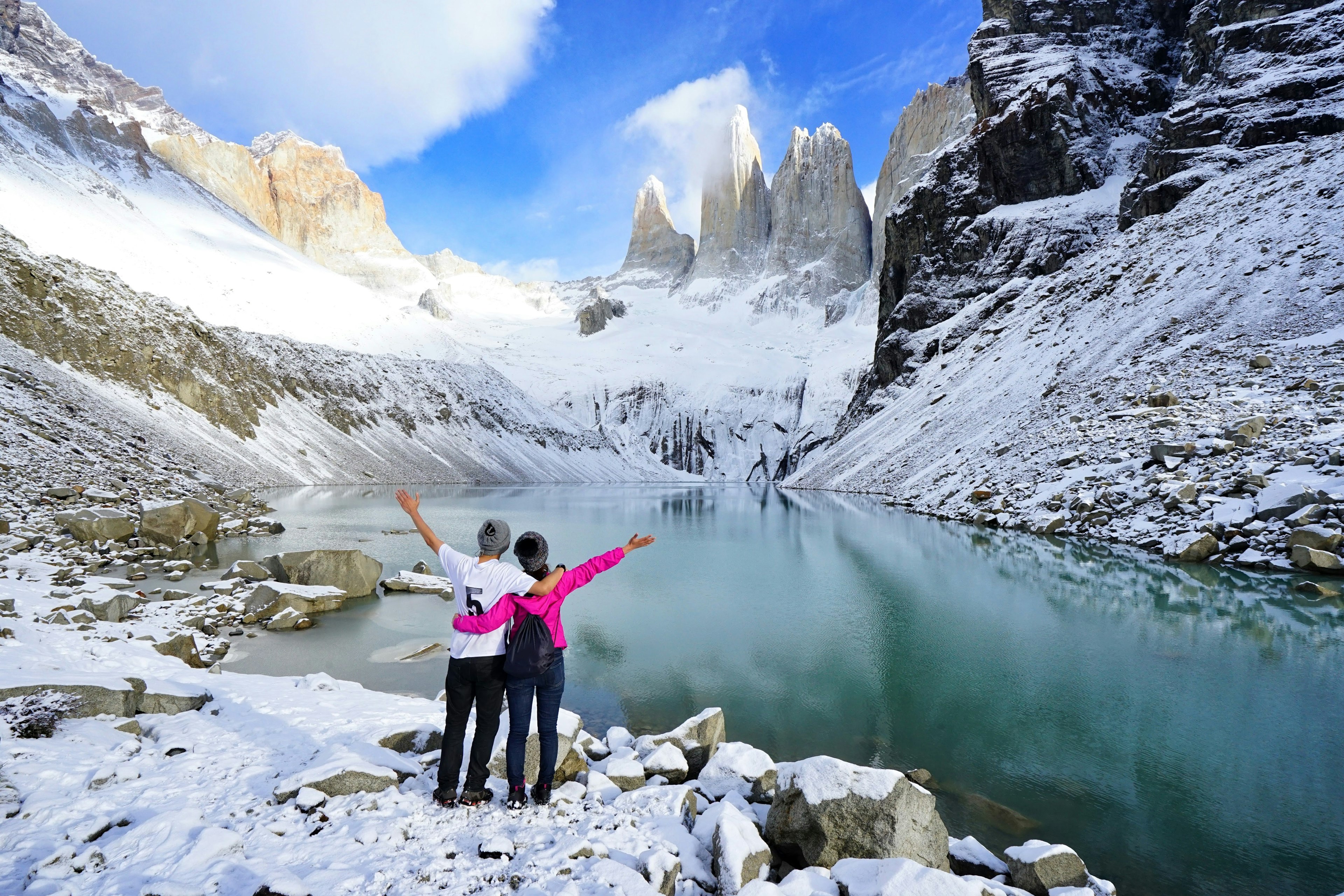 Couple admiring scenery at Mirador Las Torres, Parque Nacional Torres del Paine, Patagonia, Chile