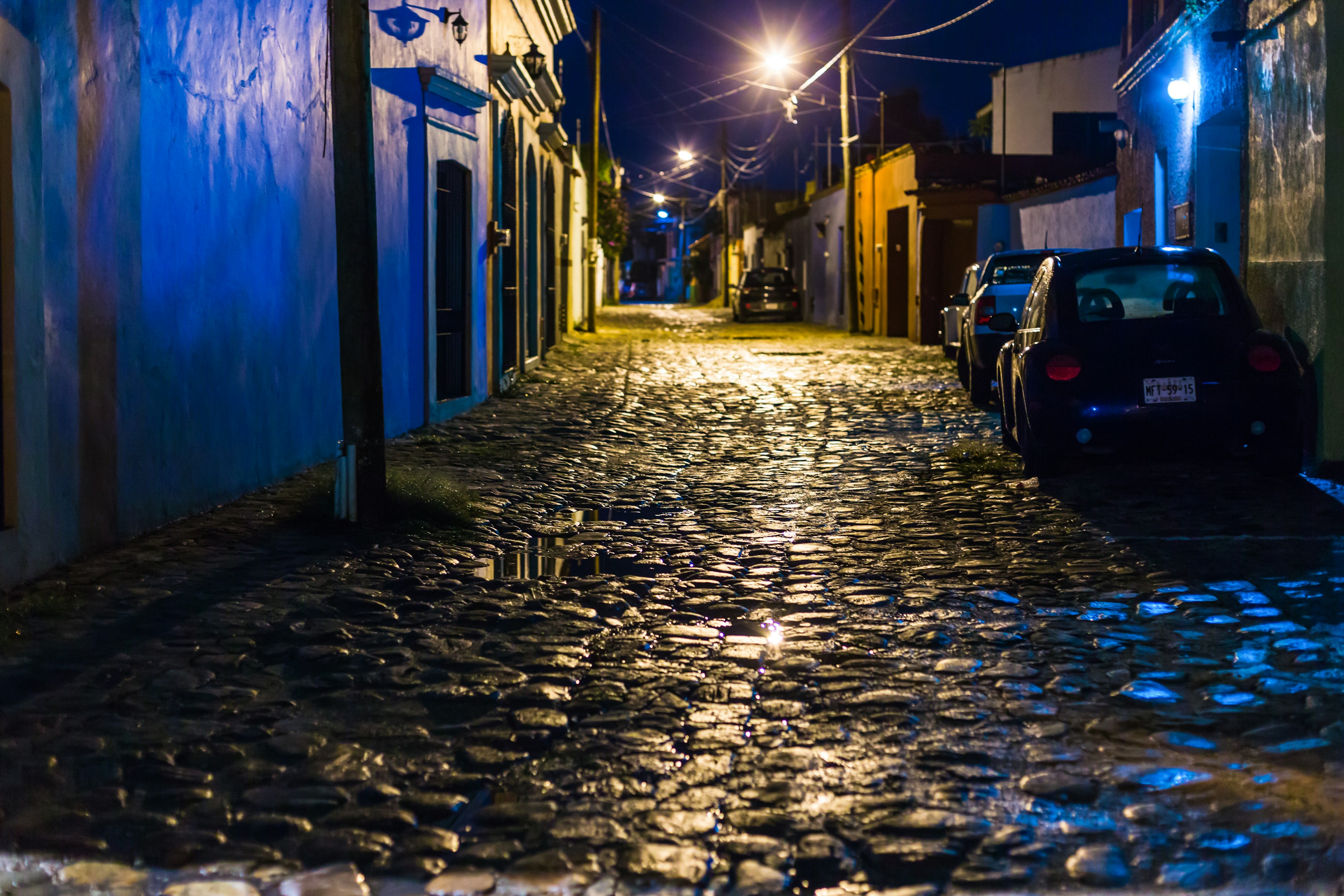 A cobblestone road at night glistens after a rain in Jalatlaco, Oaxaca City, Mexico