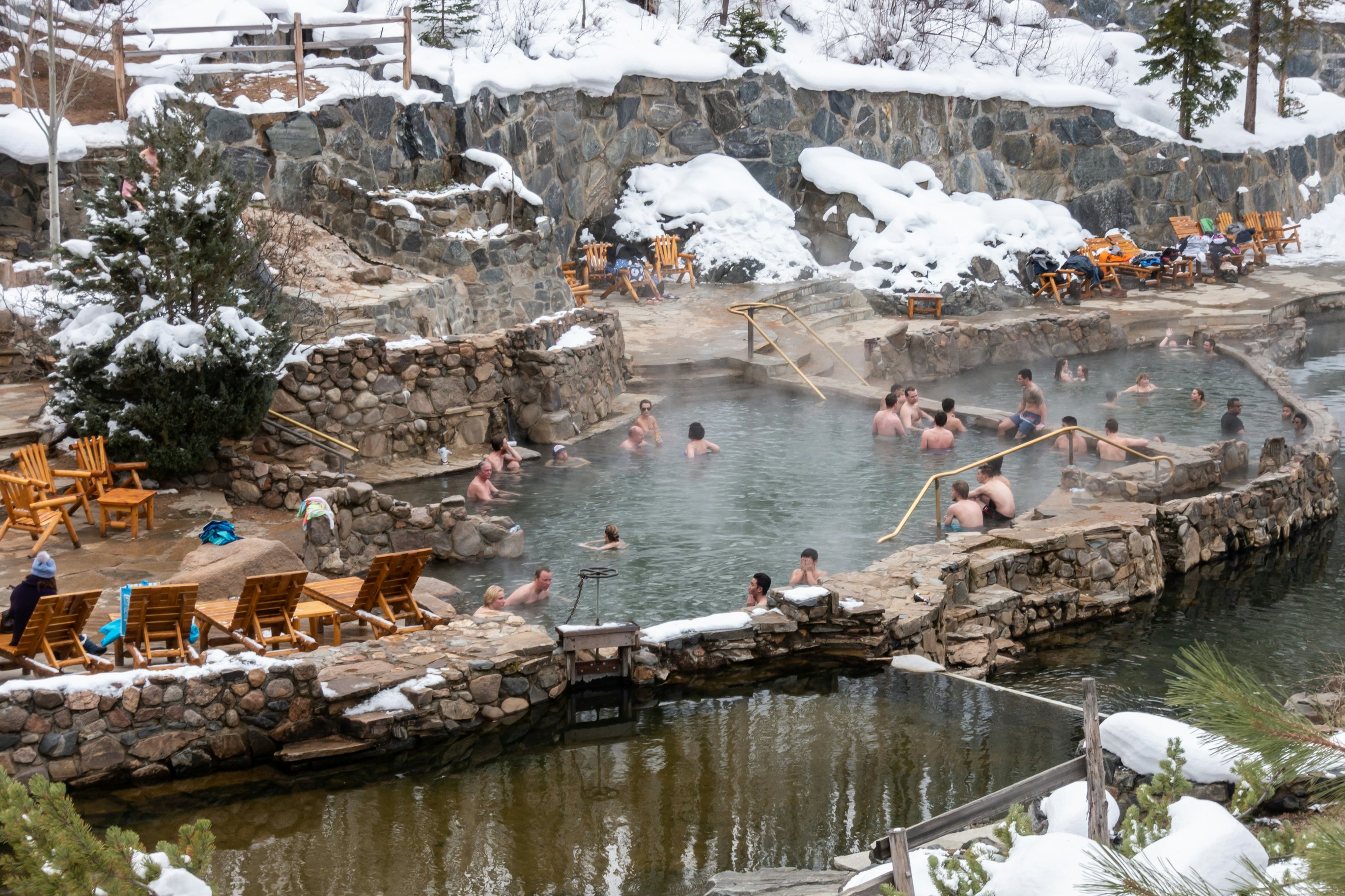 People enjoy the outdoor Strawberry Park Hot Springs.