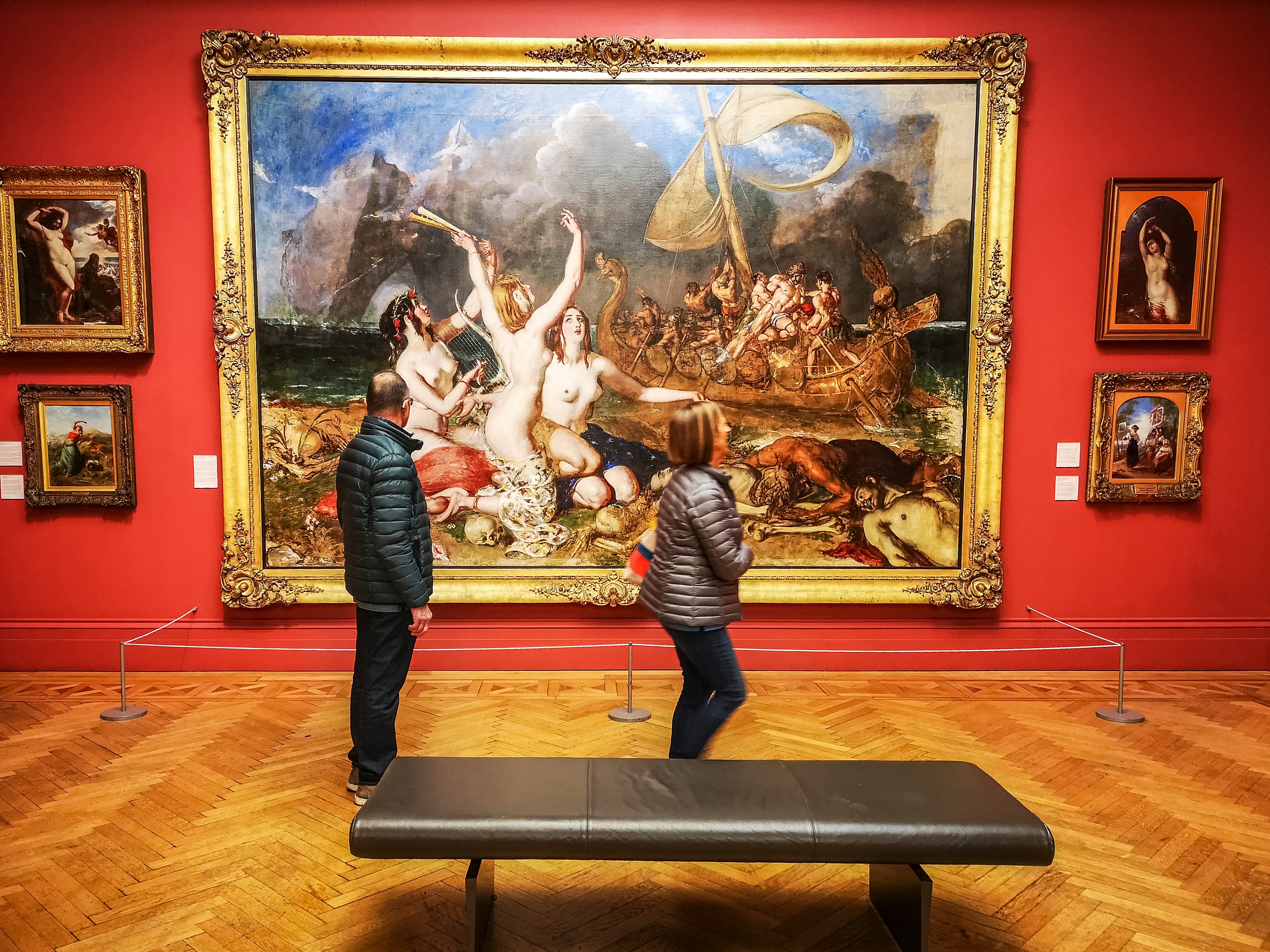 Visitors walk by paintings in the famous Manchester Art Gallery, Manchester, England, UK