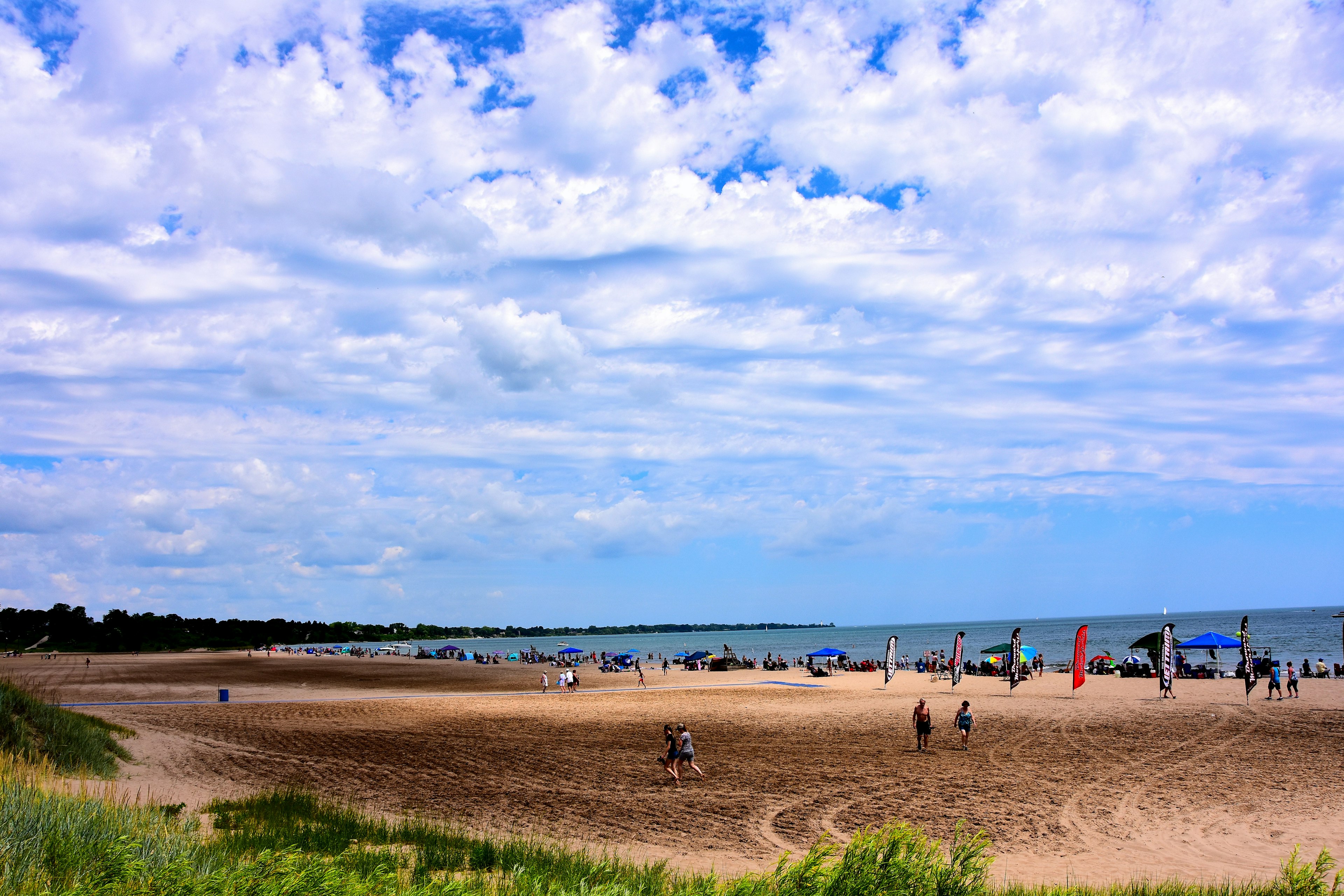 Many people enjoying the beach activities at North Beach on a beautiful summer day