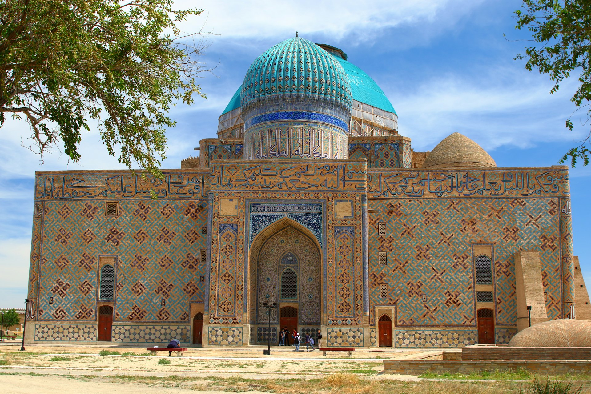 A historic mausoleum with a blue dome in Turkestan, Kazakhstan