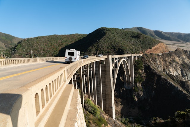 A camper drives across the arched Bixby Bridge in Big Sur