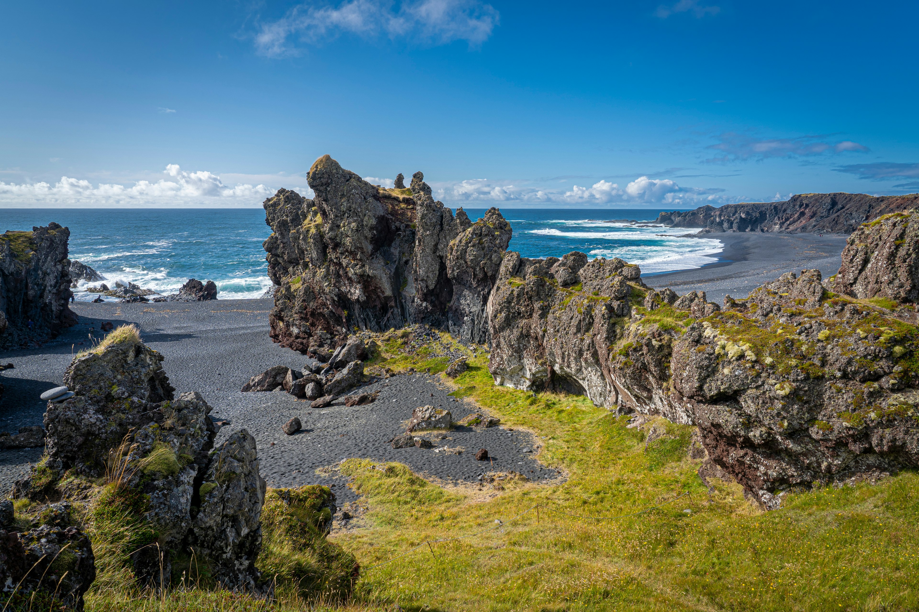 Rocky cliffs protrude into the sea dividing this beach in half